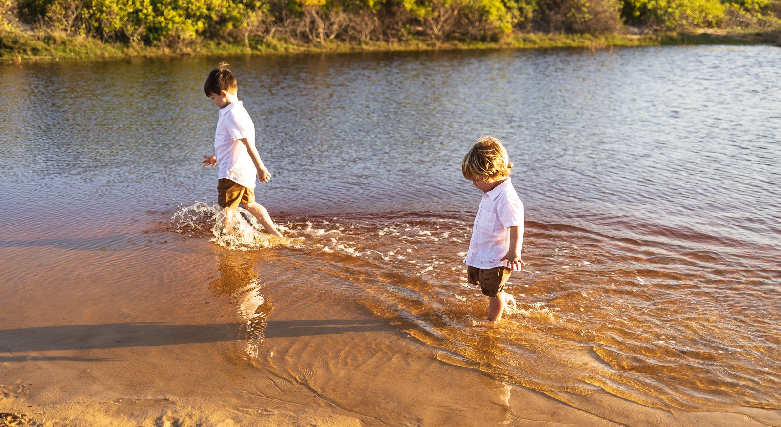 Nicole Johnson Photography ~ Brothers walking in water and splashing
