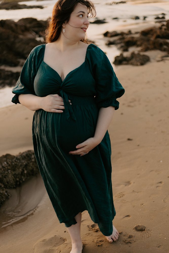 Nicole Johnson Photography ~ Maternity session on beach mother with hands on baby bump