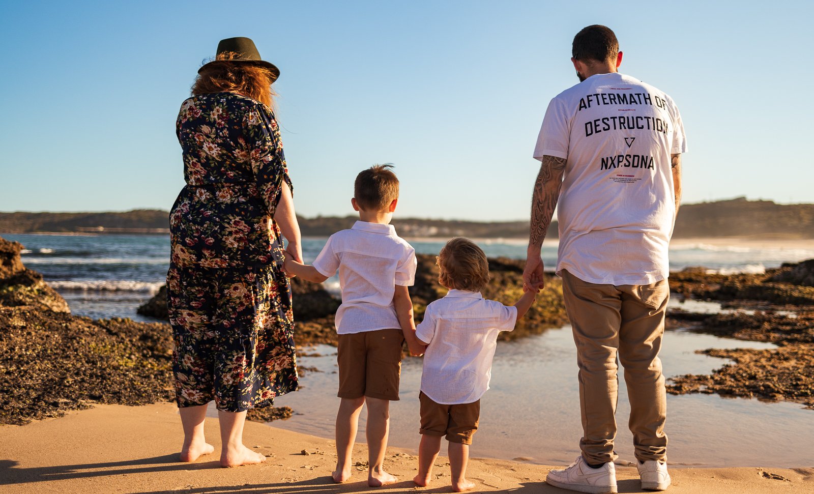 Nicole Johnson Photography ~ Family photo on beach looking out to the ocean
