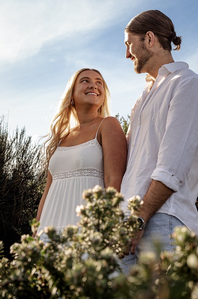 Nicole Johnson Photography ~ Couple looking at one another smiling