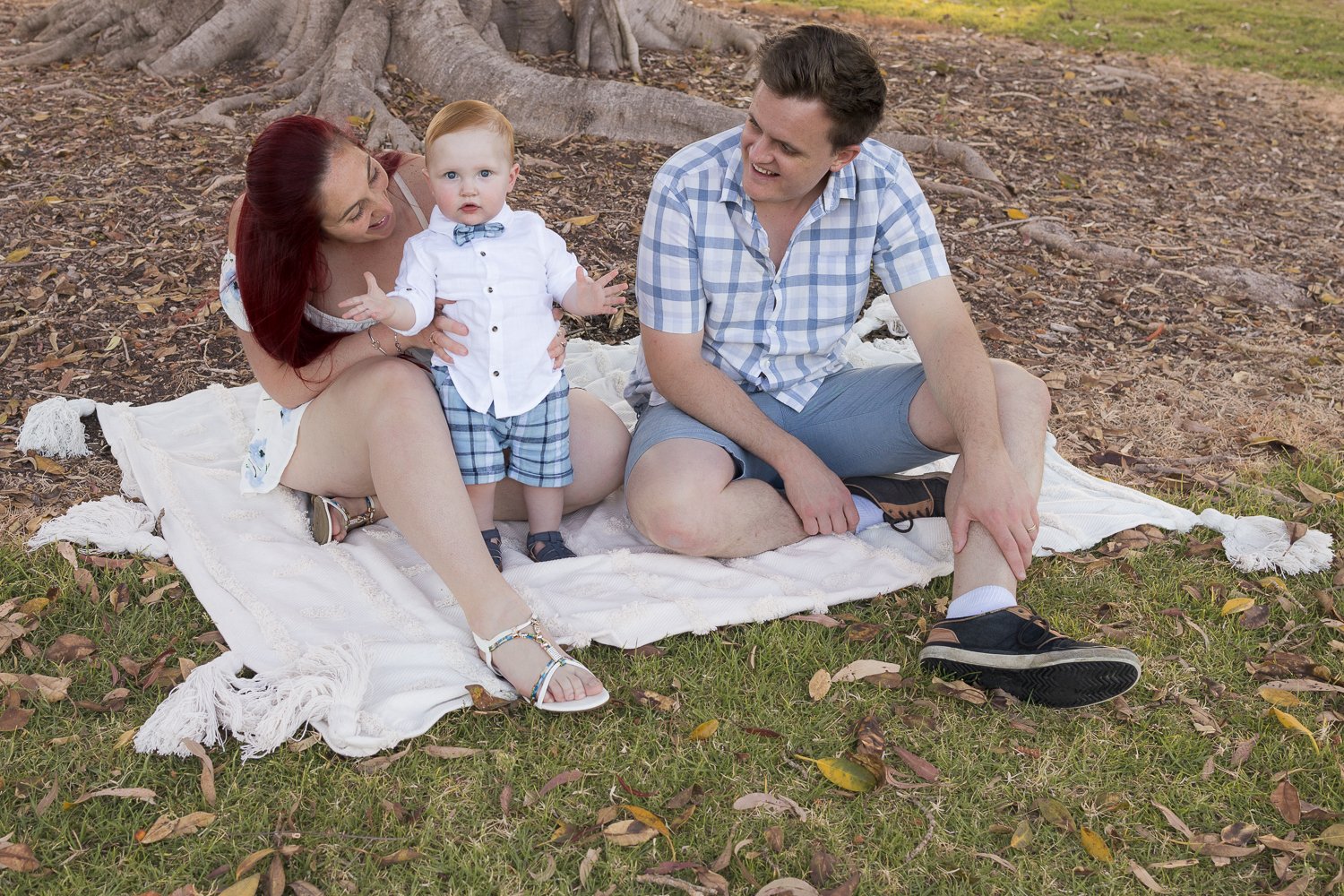 Nicole Johnson Photography ~ Family session, family of three on rug in park