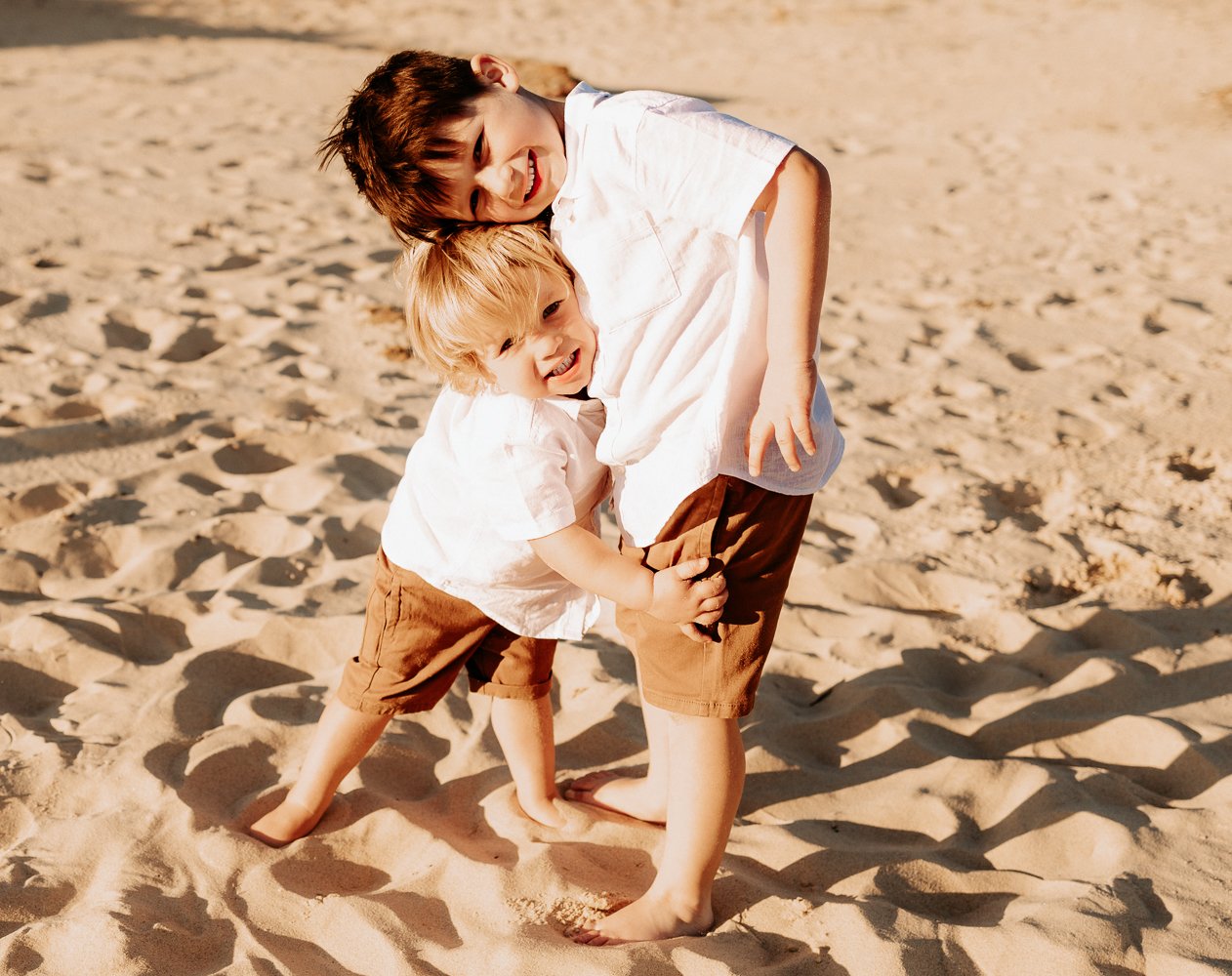 Nicole Johnson Photography ~ Brothers embrace on sand