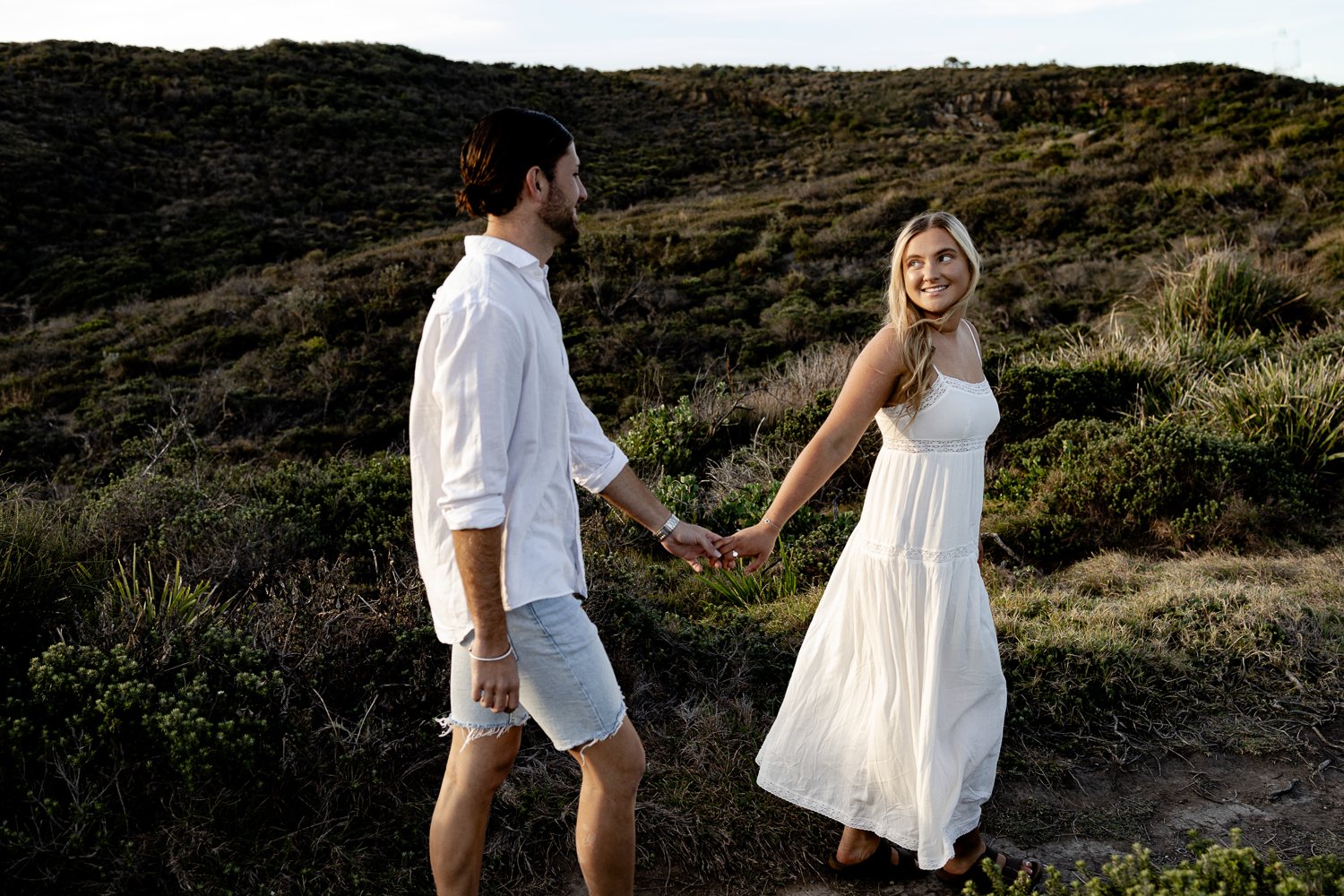 Nicole Johnson Photography ~ Couple session. Walking holding hands, woman looking back at partner