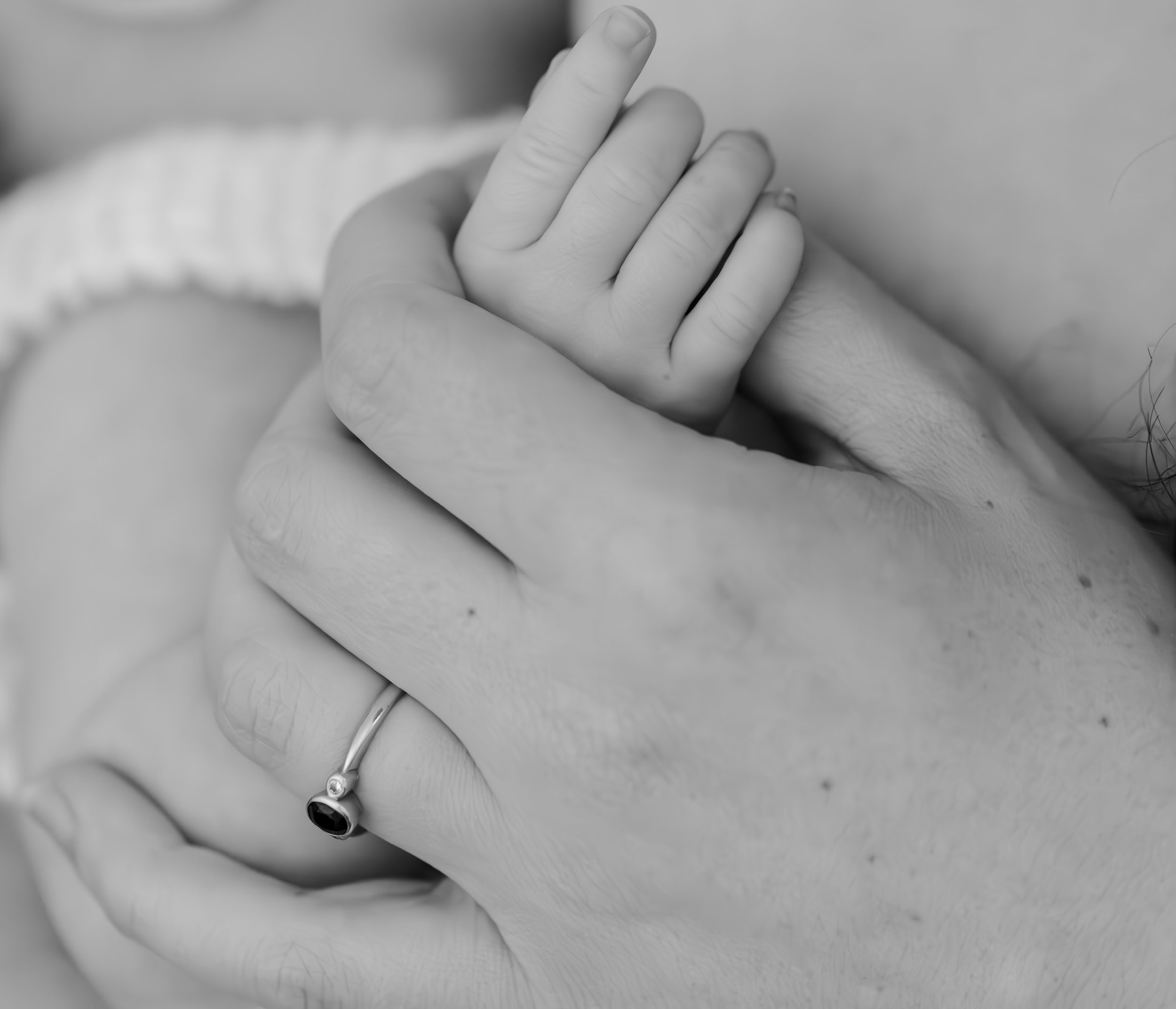 Nicole Johnson Photography ~ Newborn Session. Mother holding child's hand whilst feeding