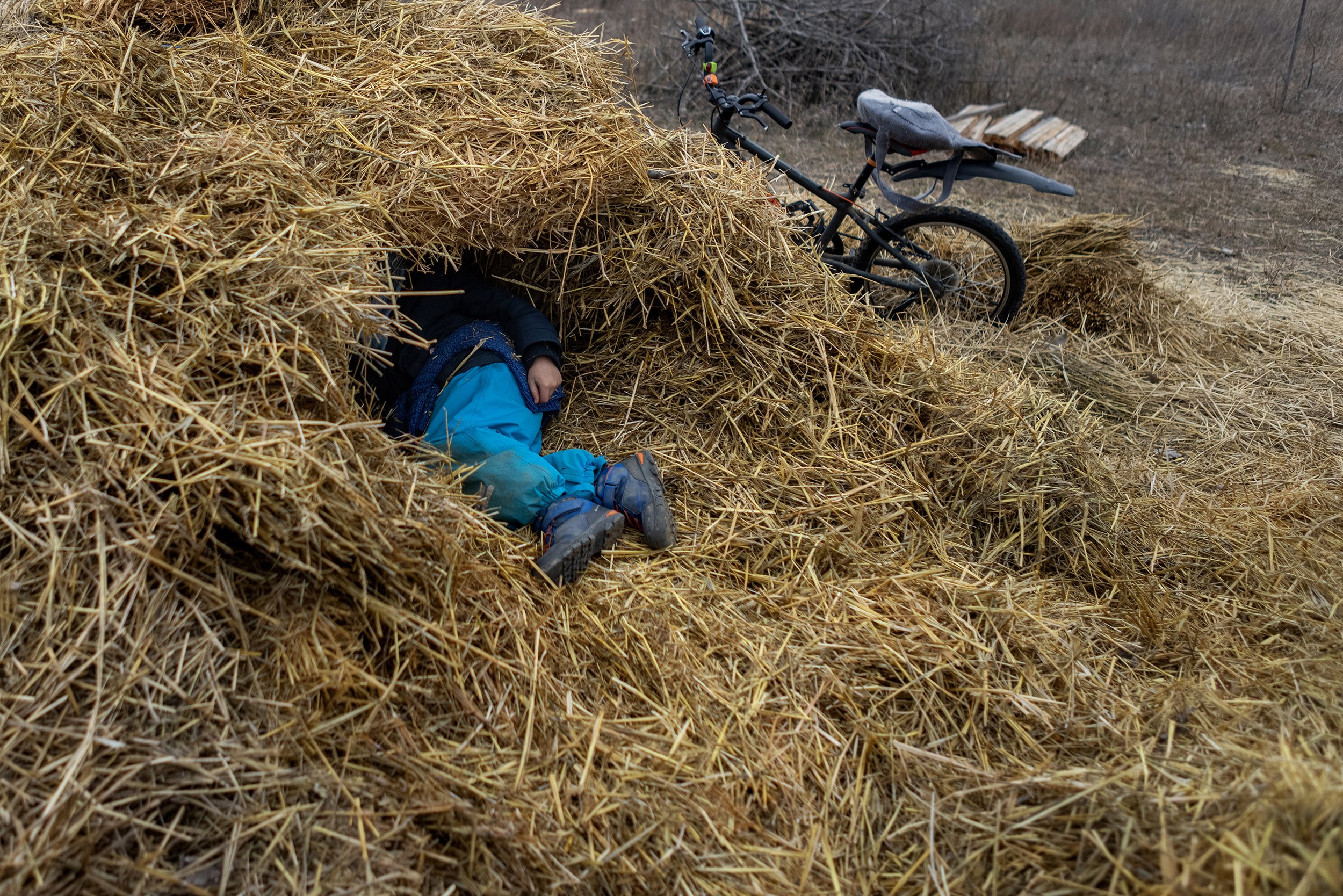  Little boy playing in the straw on the Eco-meadow in Nyim, on February 19, 2022.  