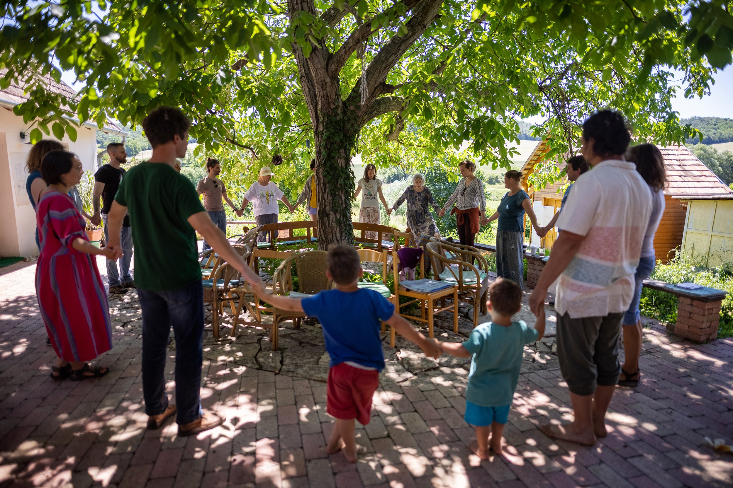  Playing circle game at the Új Koma Háló (network of Hungarian ecological local communities) meeting in Nyim on June 12, 2022. The presence of children sometimes interferes with adult programs, but as they are also seen as valued members of the commu