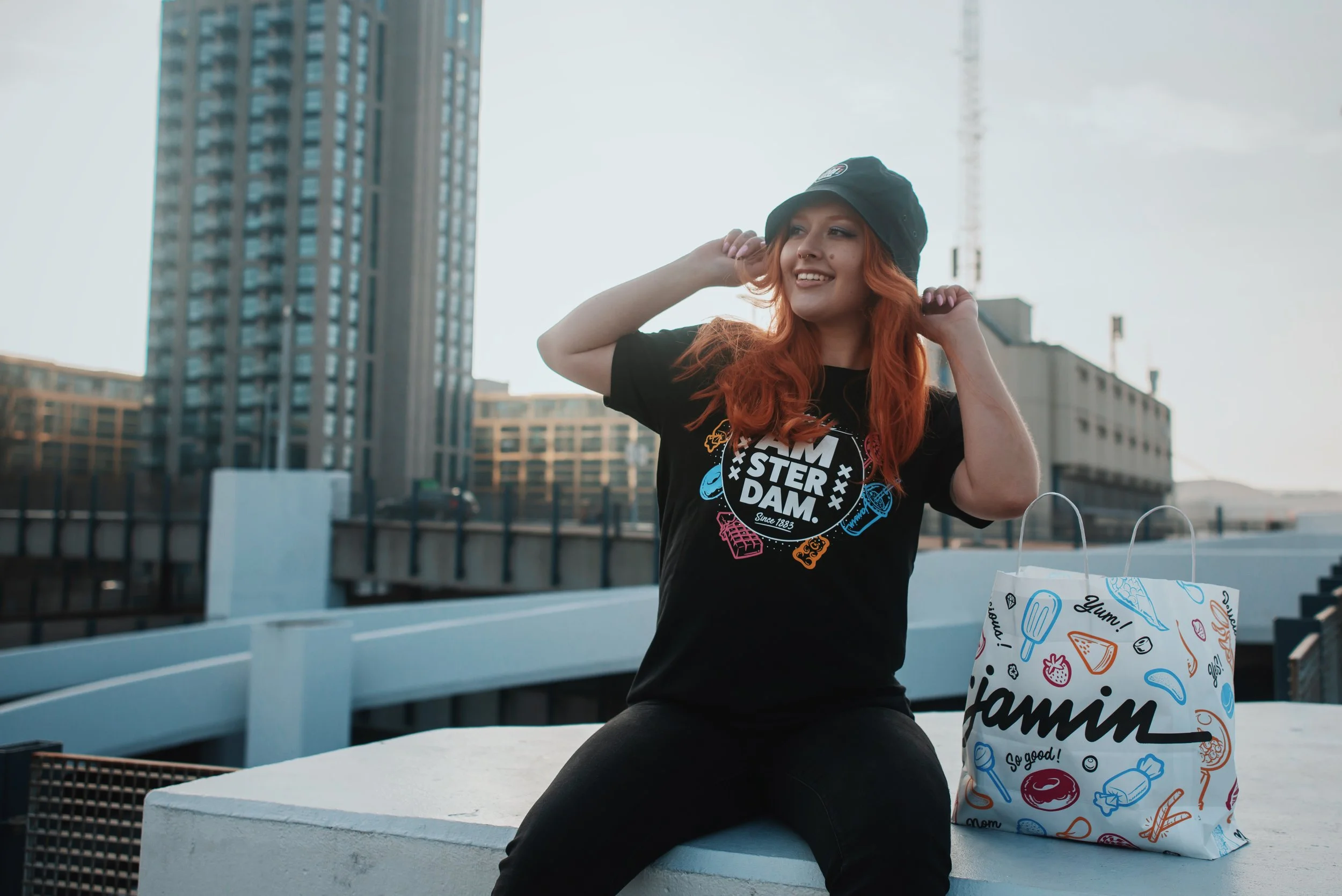 A dutch model with red hair and a smile modelling for a brand Jamin and shooting a campaign for their Amsterdam Damrak Merch