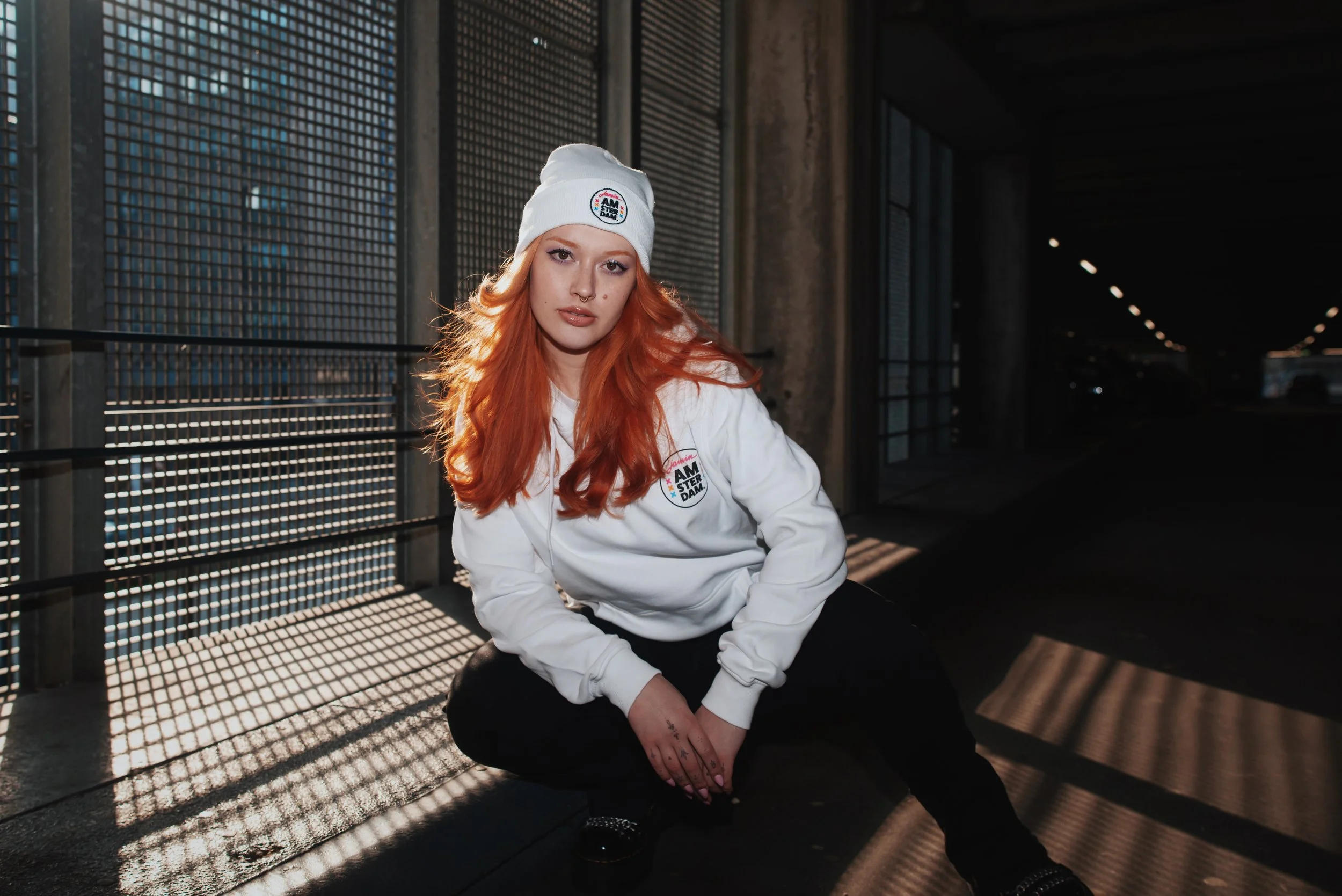 Dutch red head model with tattoos posing for the brand Jamin, a candy store for their Merch line for Amsterdam Damrak