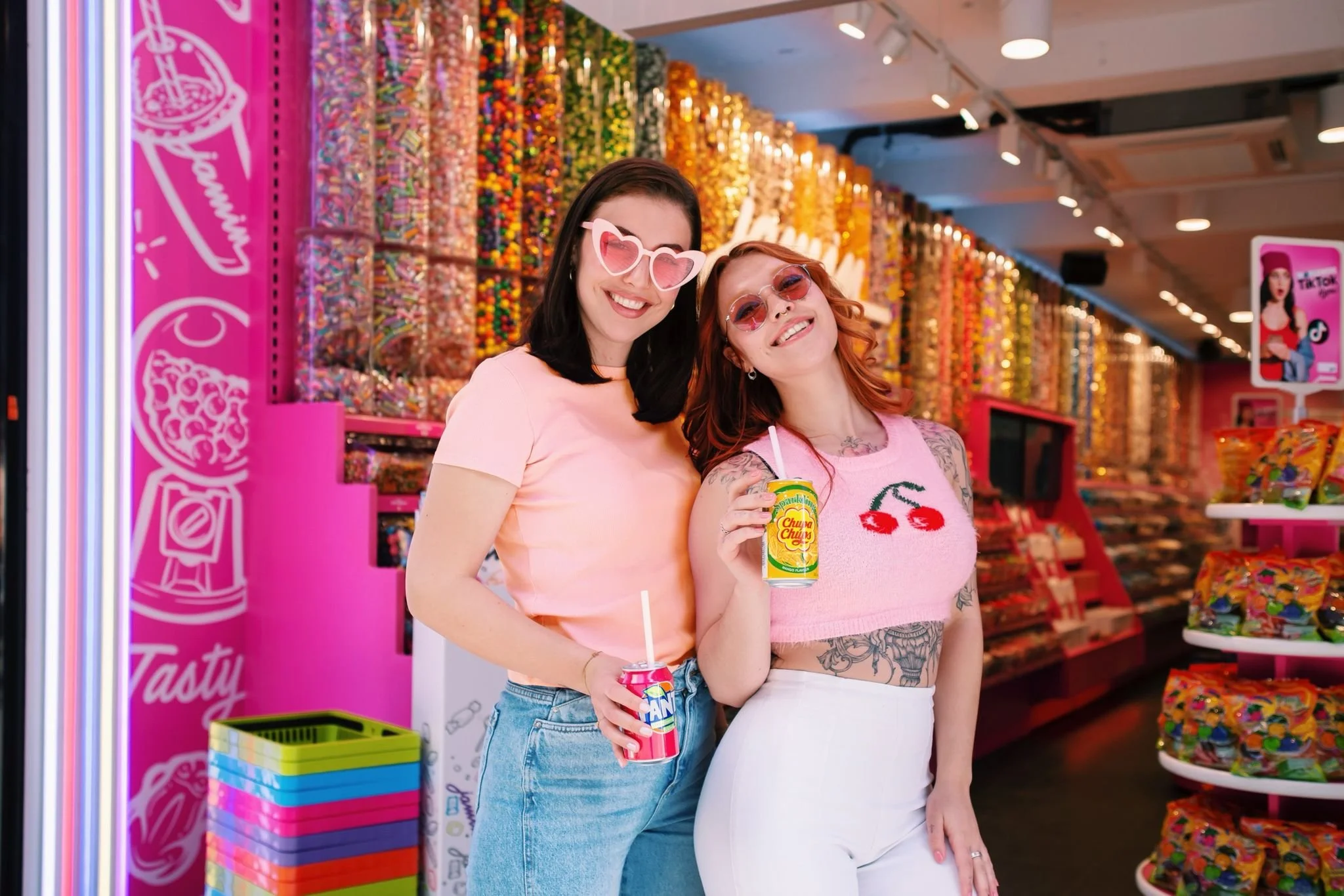 Two girls modelling for a candy store in Cologne, Germany for Jamin. A very colourful and color coordinated store. Posing with drinks.