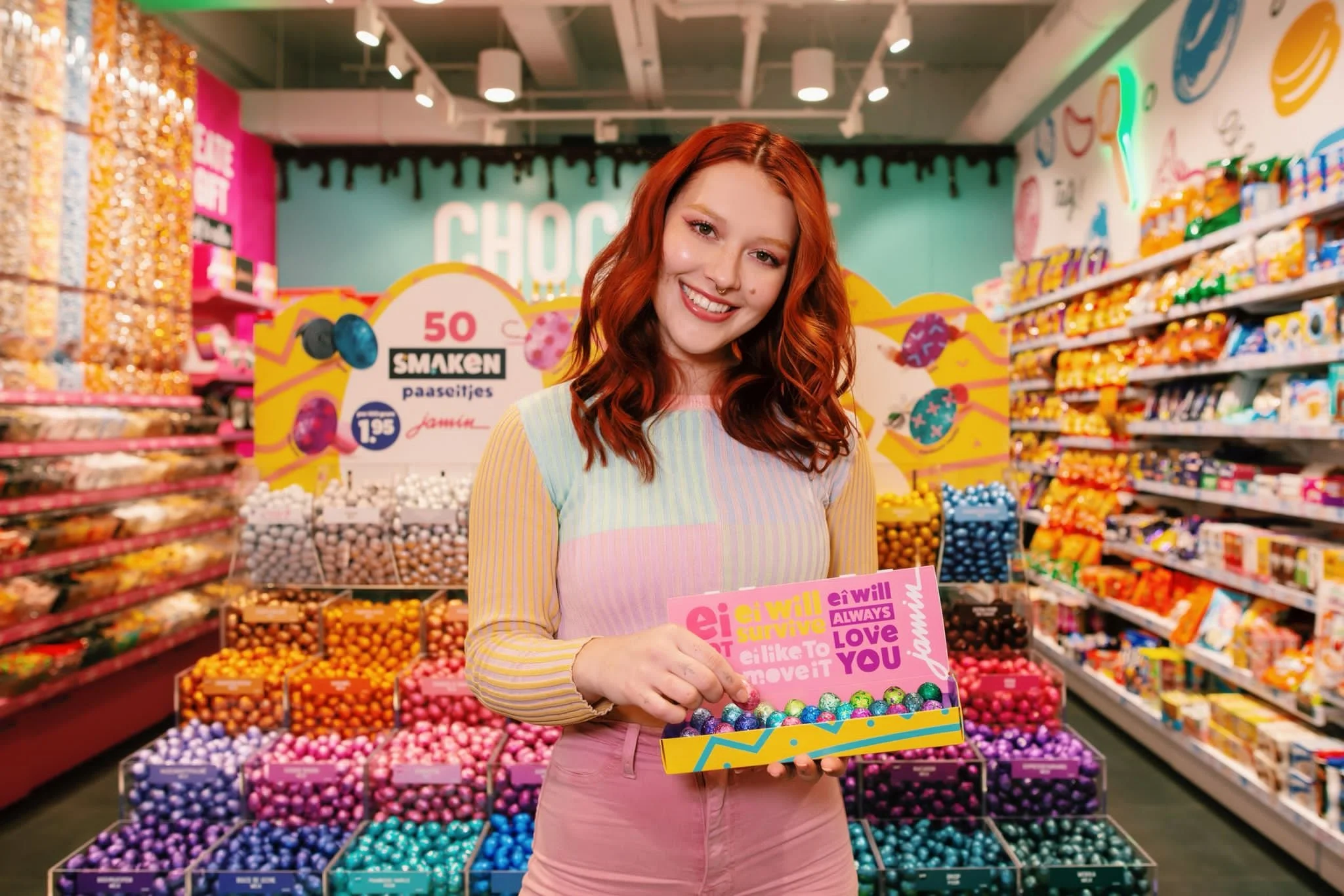 Model smiling with easter eggs in a very colourful and color coordinated store called Jamin for the Easter Campaign 2022