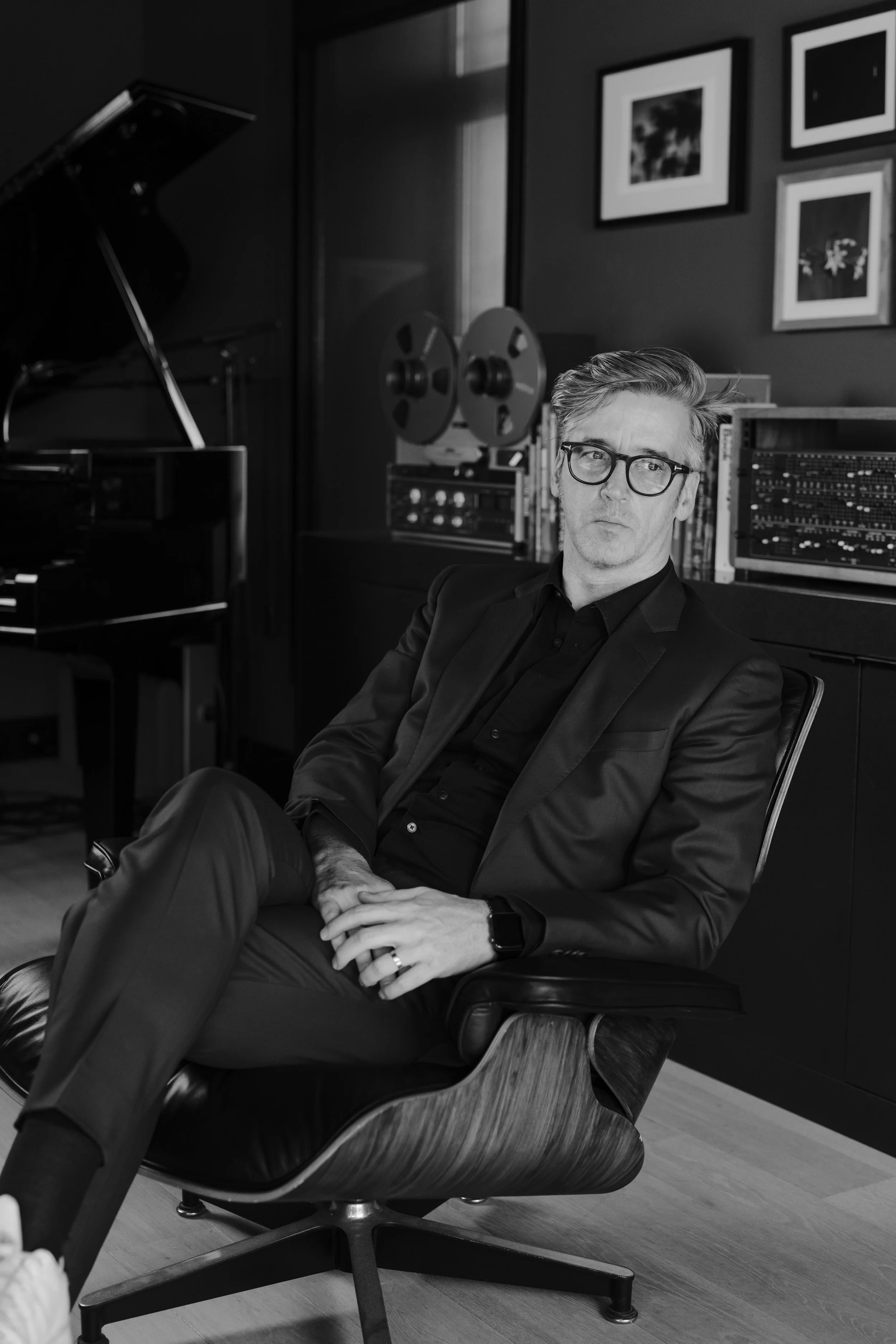 Peter Baert in his studio, with a grand piano and a reel-to-reel tape recorder