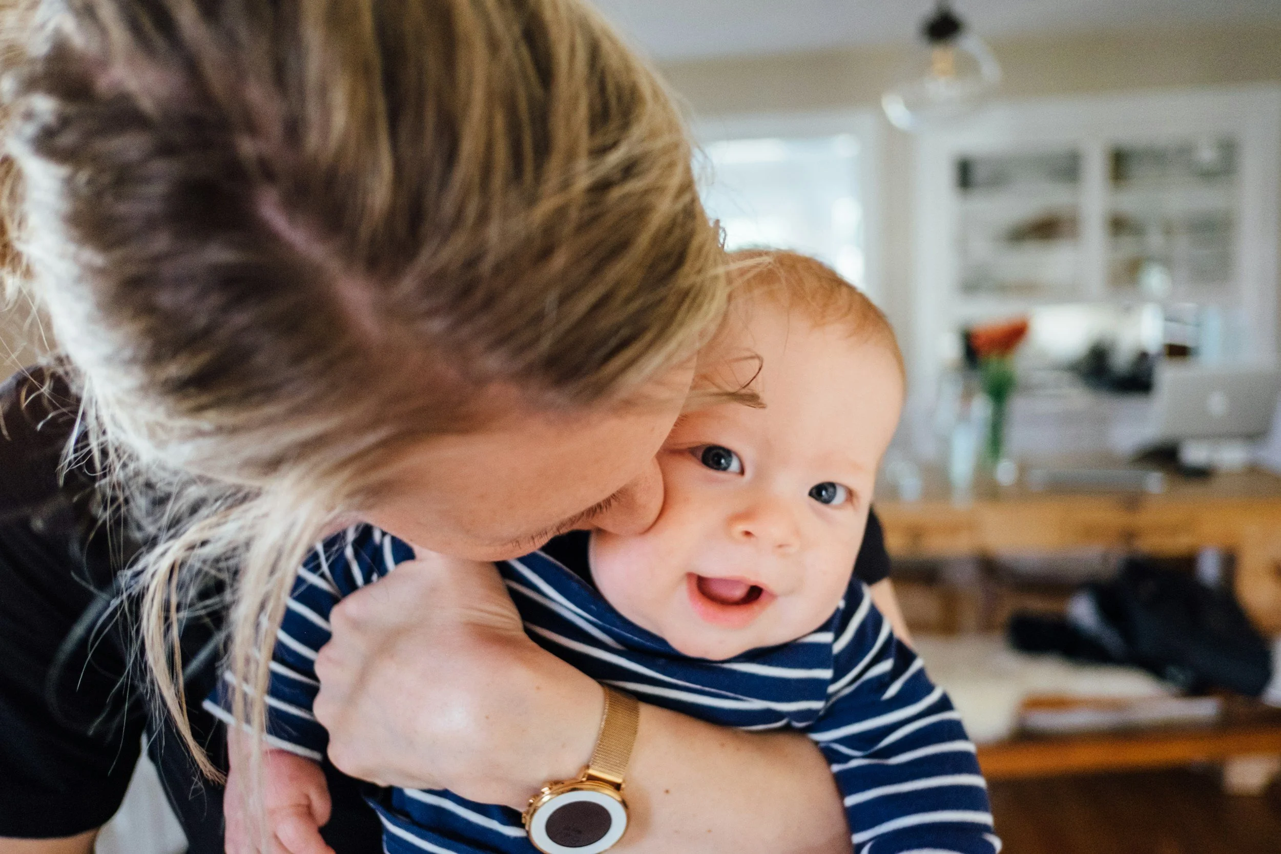 Mother with baby, in a kitchen in England