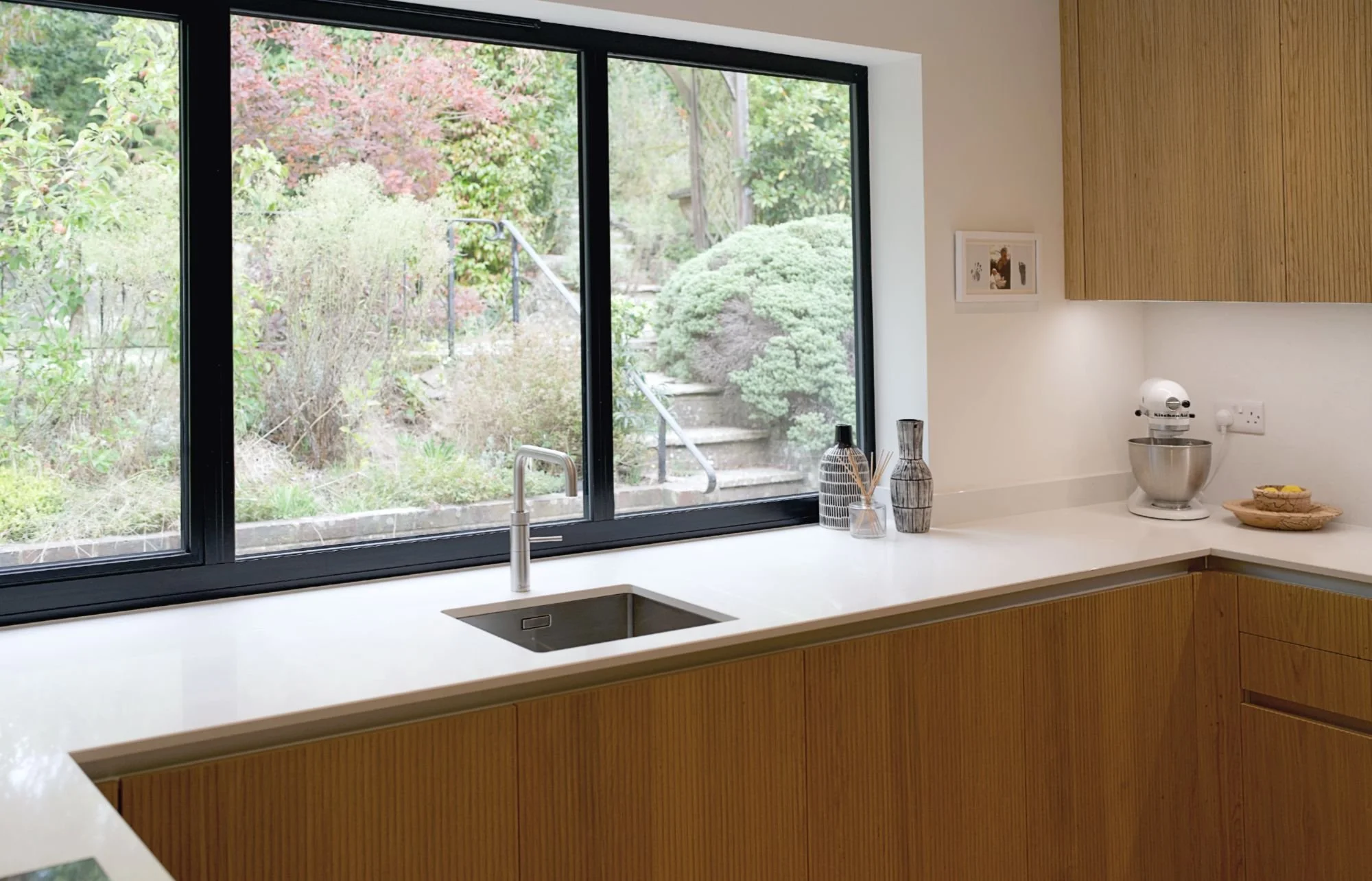 Contemporary kitchen with wood-finished cabientry