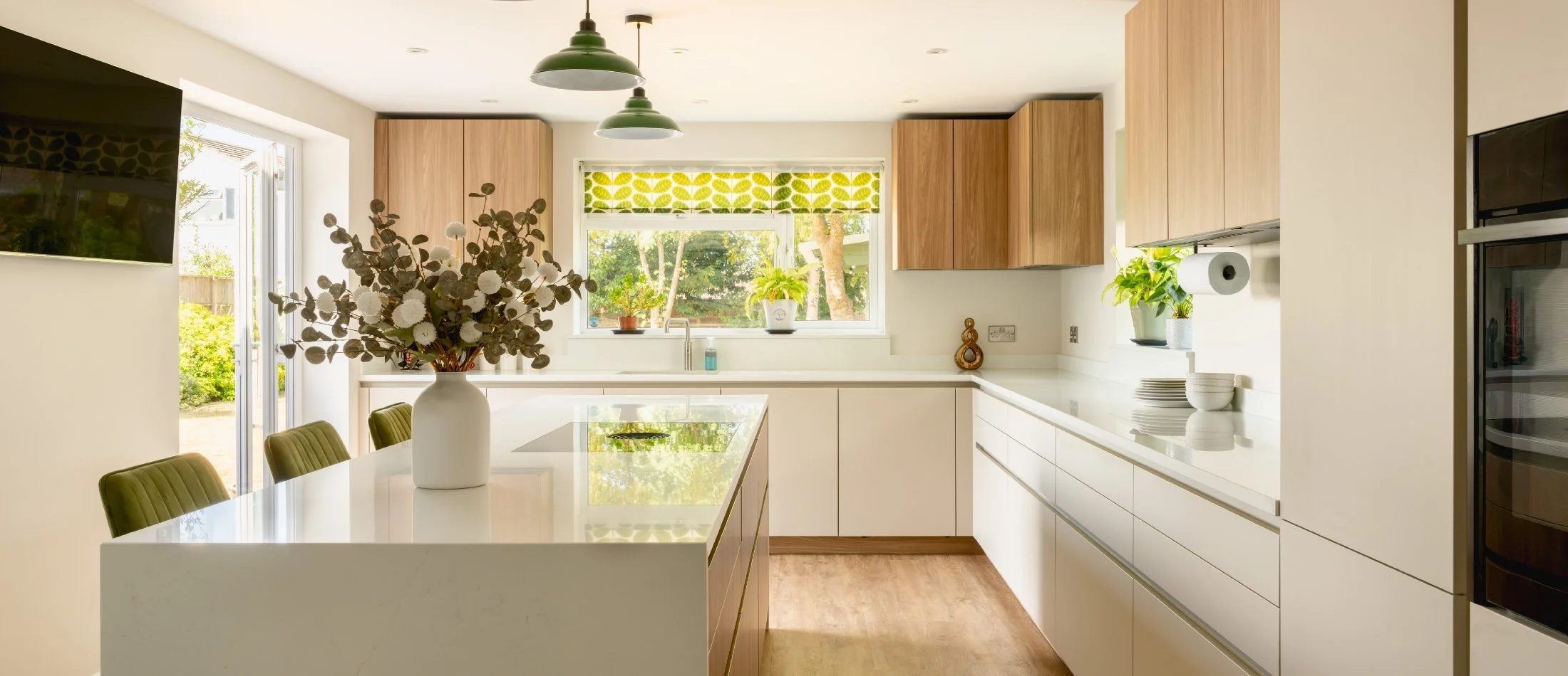 Contemporary handleless kitchen with warm nude cabinetry and complementary worktops