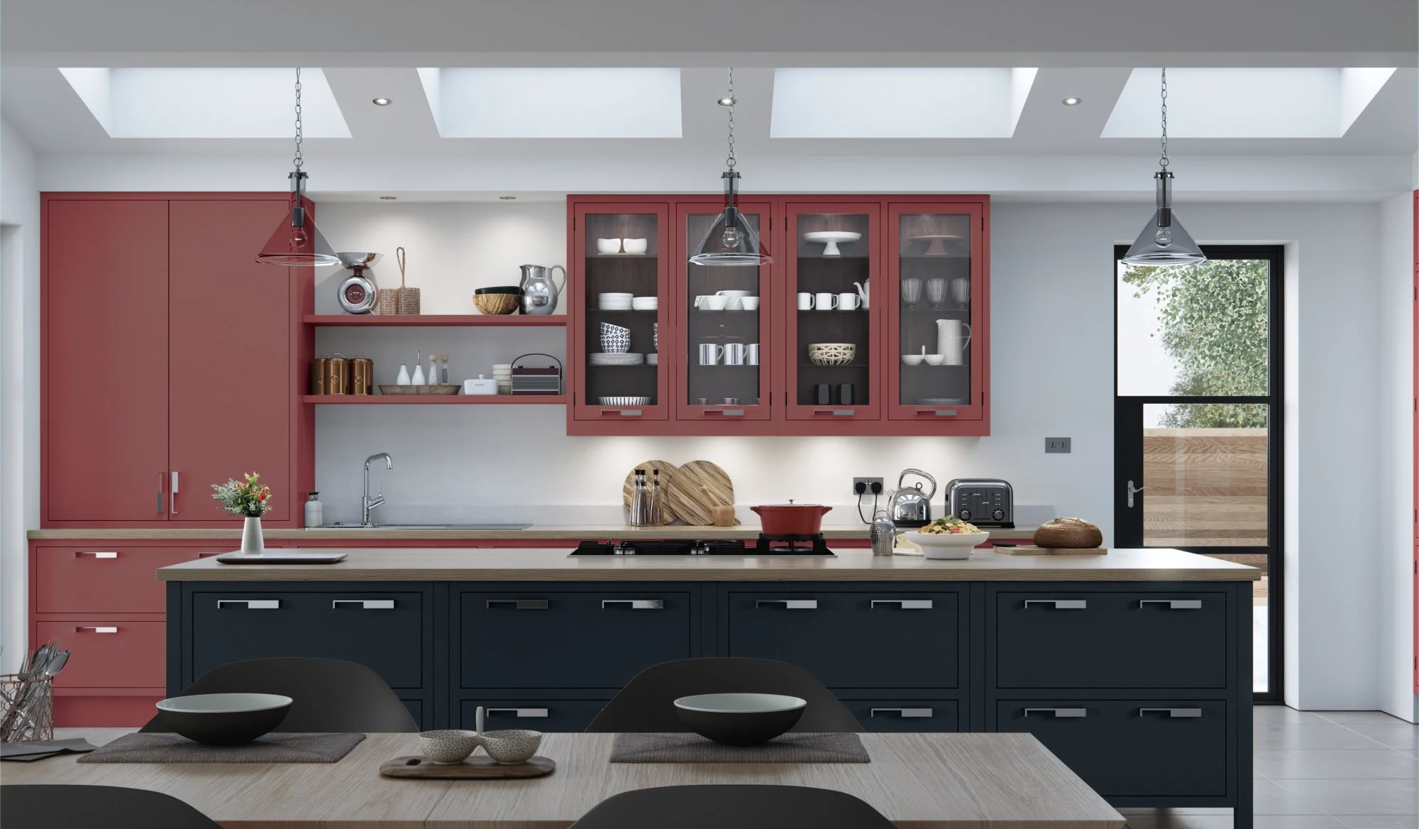 Modern kitchen with red and black cabinets, open shelving with dishware, a kitchen island with a bowl of food, and skylight windows overhead.