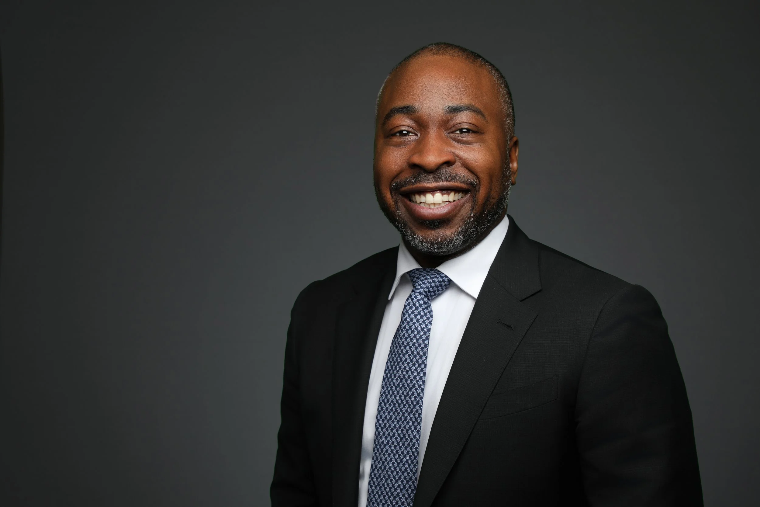 Headshot of a man in a suit and tie