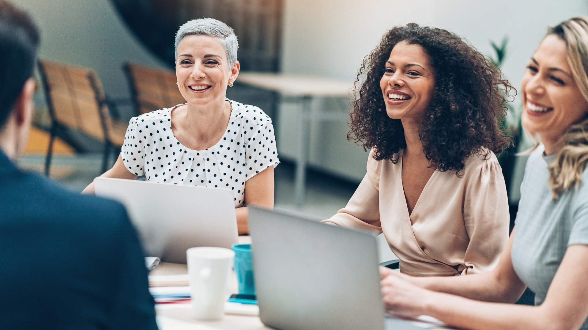 Group of midlife women interacting during a work meeting.