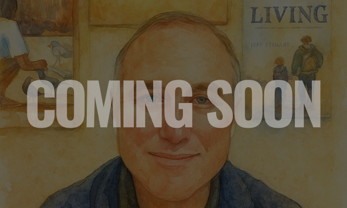 A person with glasses smiling in front of a wall with a poster, with the text "COMING SOON" overlaid.