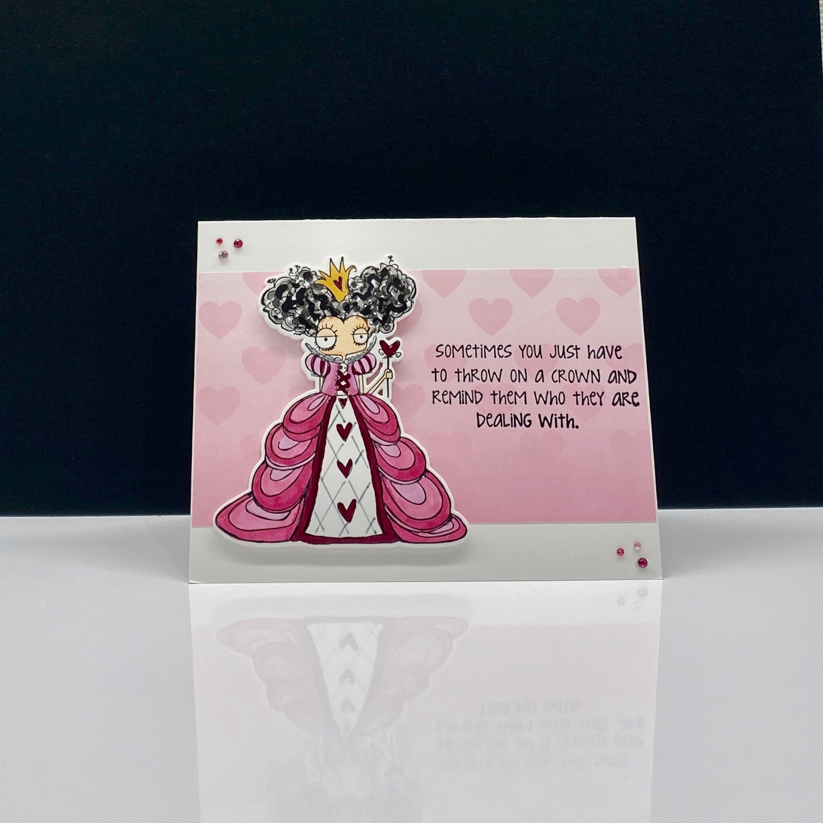 Greeting card with a cartoon queen and text.