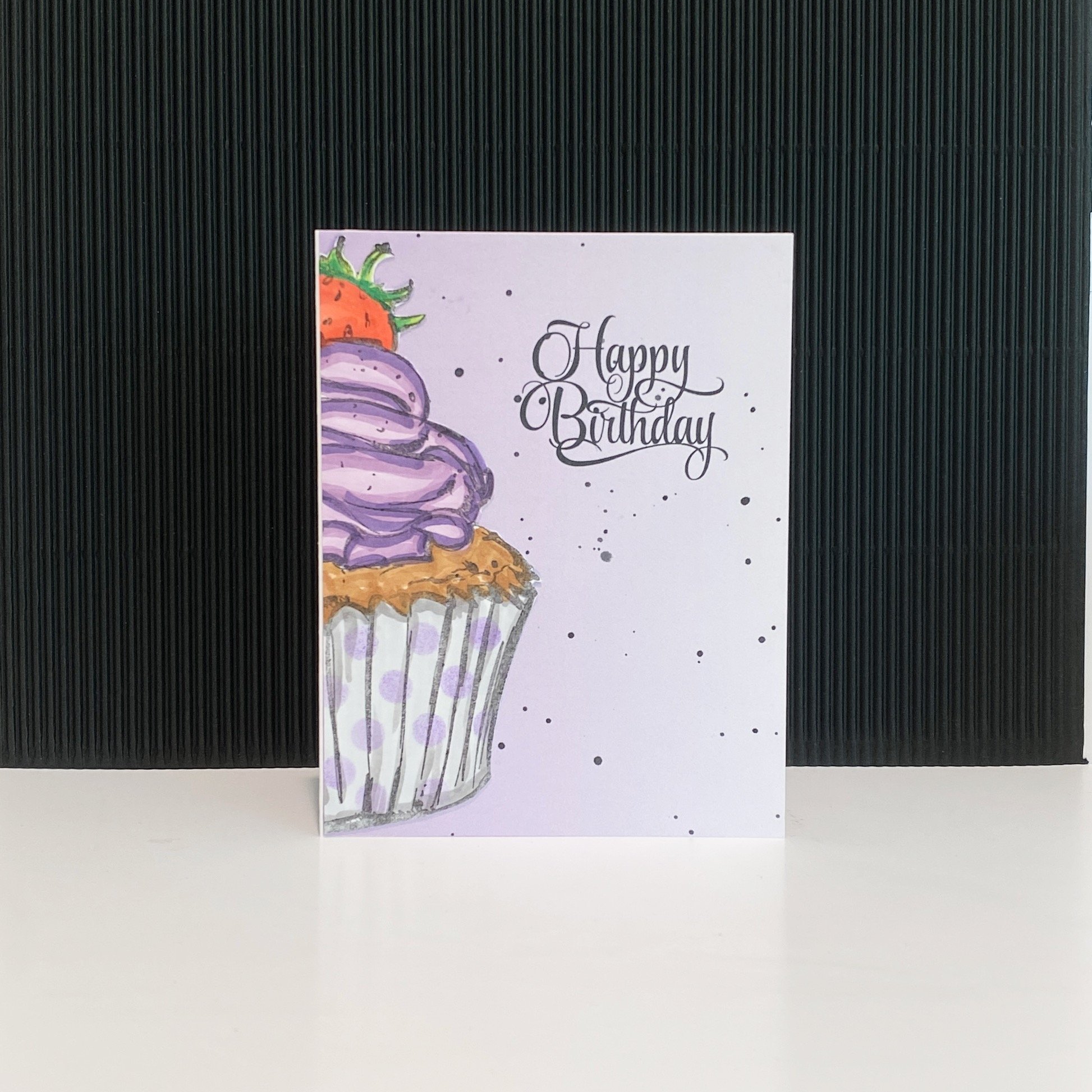 Birthday card with purple cupcake design.