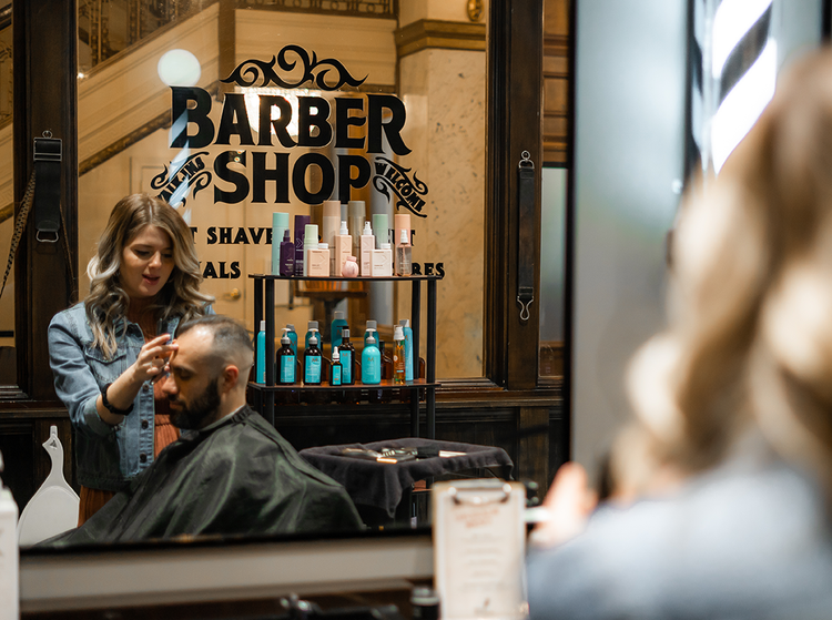Barber cutting a guest's hair at The Barber Shop at Hotel Blackhawk