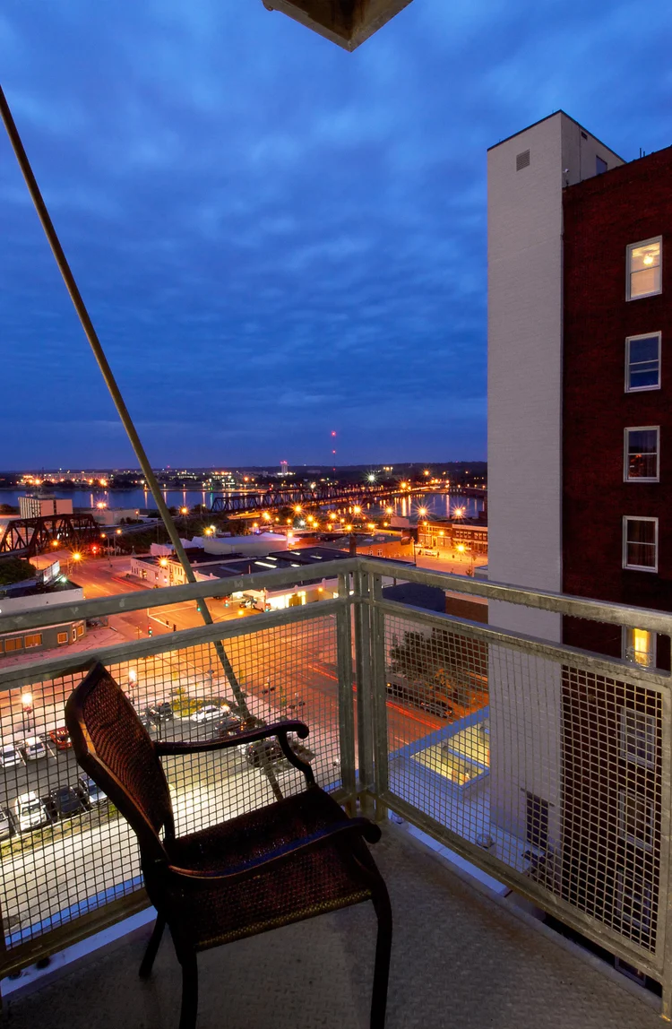Balcony at dusk overlooking downtown Davenport and the Mississippi River