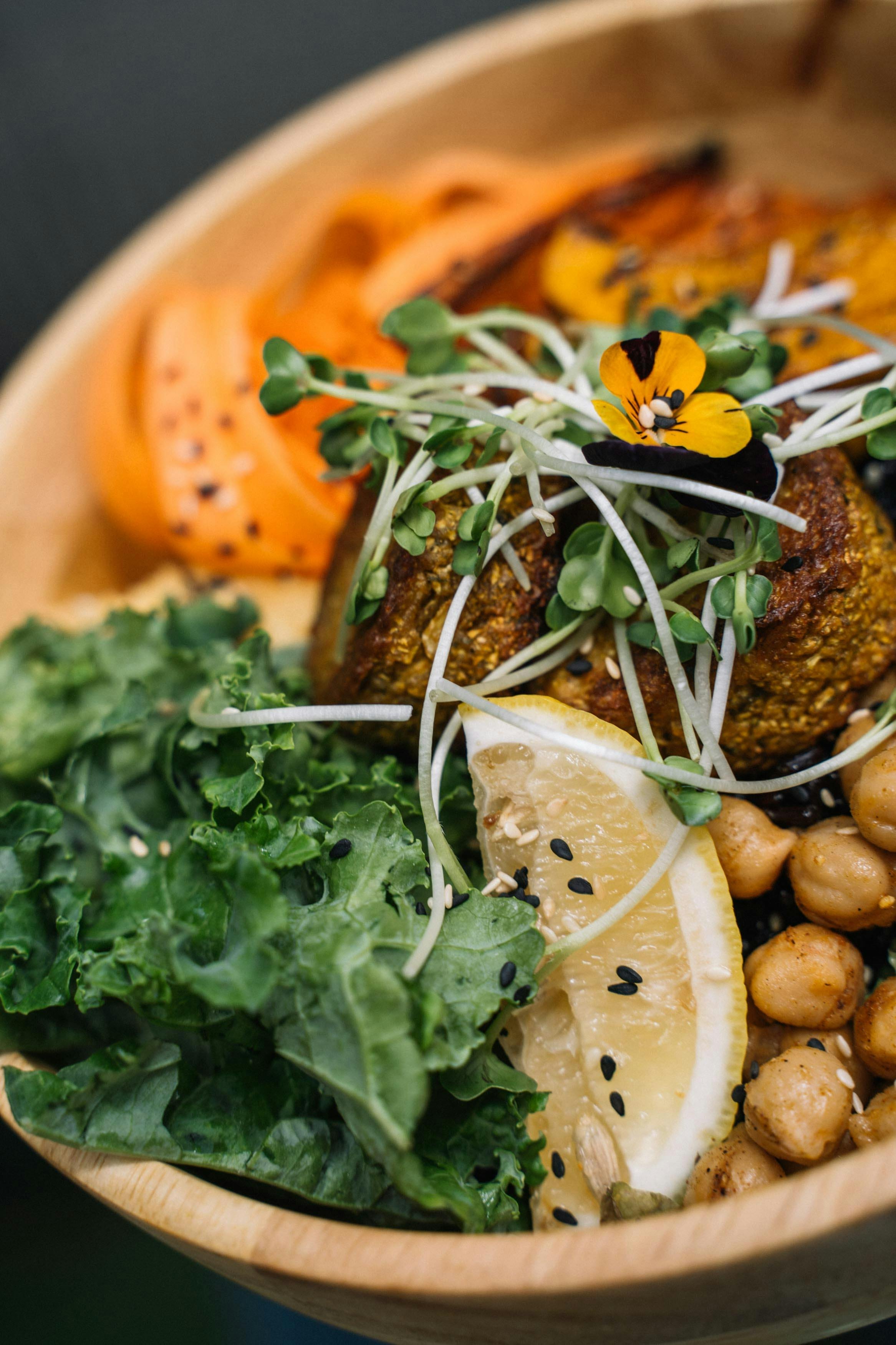 a bowl with falafel, chickpeas and plant based foods