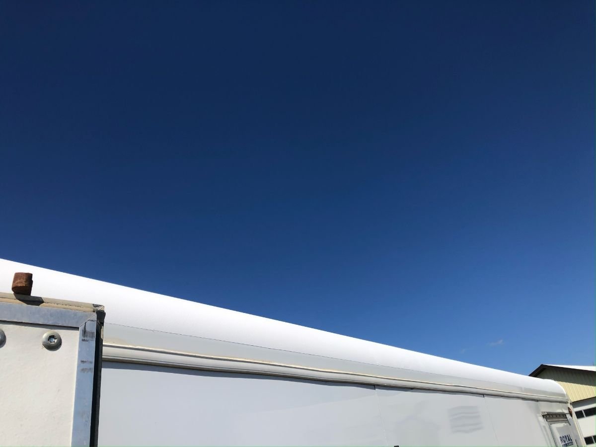 Elastomeric coating on roof of enclosed trailer