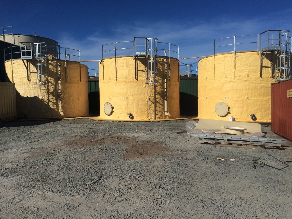 Spray foam water tanks in Kuglukuk, Nunavut