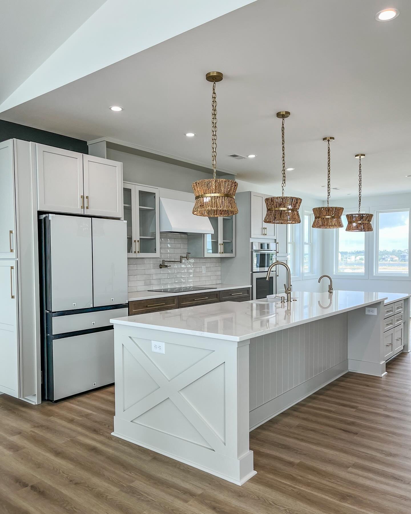 A coastal farmhouse-style kitchen with stunning features around every corner, quite literally.

Swipe to see this stunner with an extended island + prep sink, and cabinetry, and drawers galore!

#coastalkitchen #farmhousekitchen #topsailisland #beach