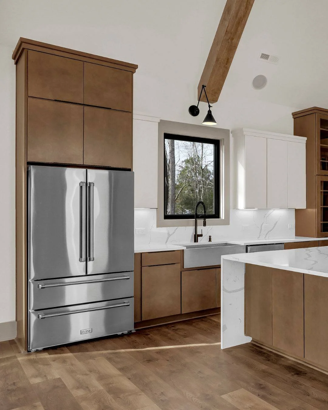 A stunning kitchen project reveal!

The perfect balance between classic warmth and simplicity. This kitchen embodies a transitional modern style, with a waterfall island, two-toned cabinetry, and architectural charm around every corner. The custom ba