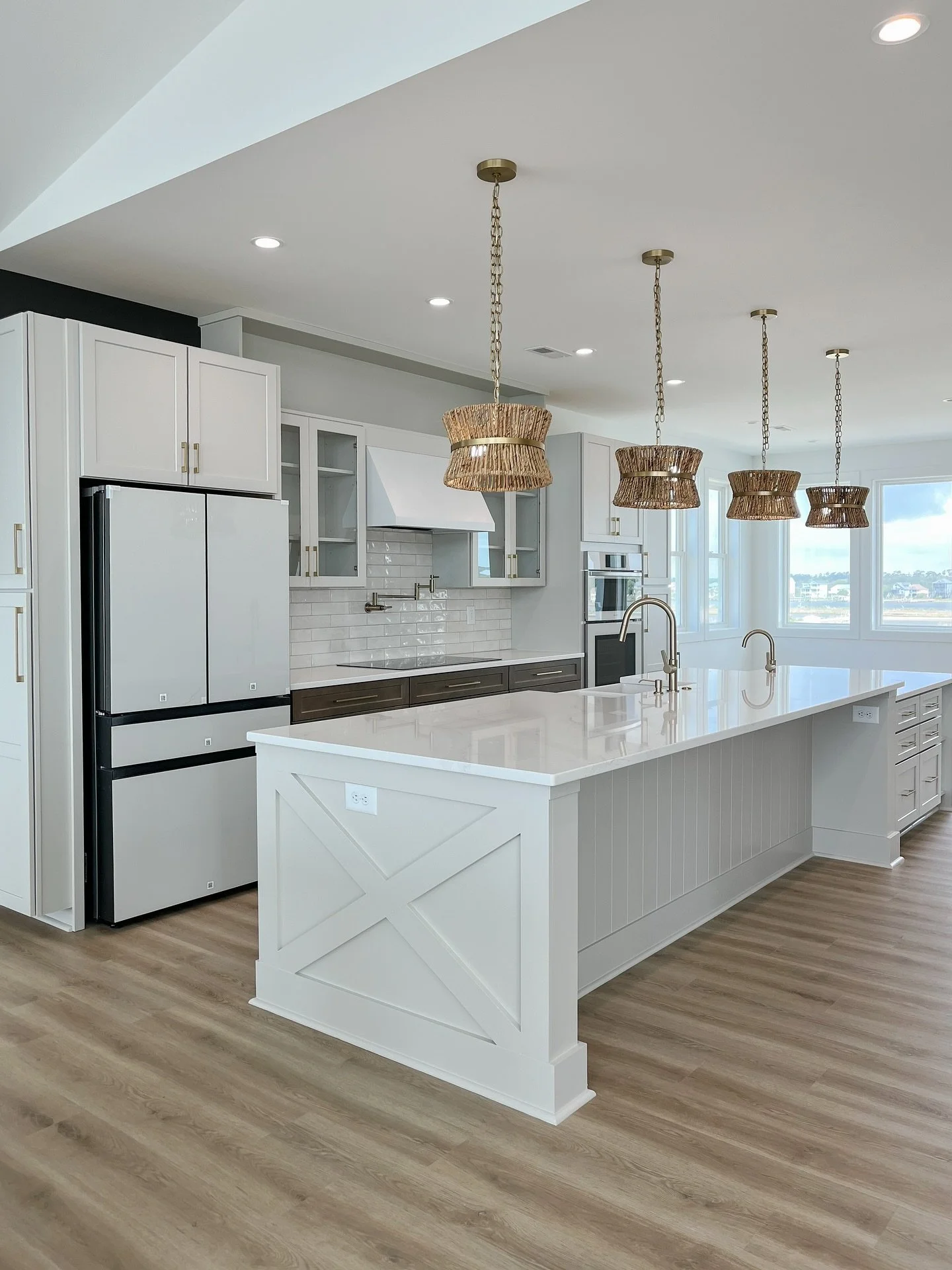 Storage, storage, and more storage.

Every inch of this kitchen was designed with intention &mdash; from the extended island (complete with a prep sink) to the built-ins that frame the fridge. A thoughtful mix of glass-front and shaker cabinetry allo