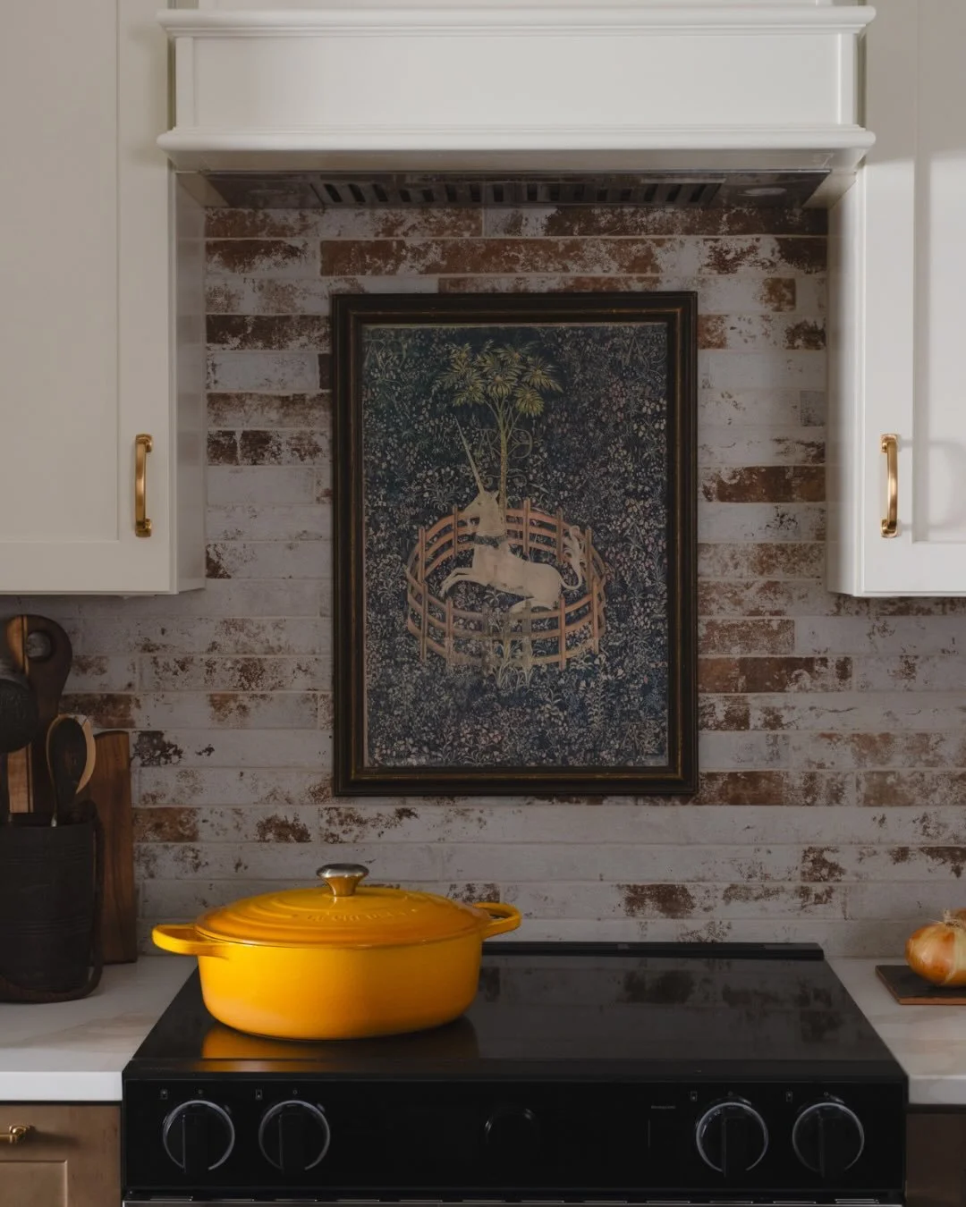 This kitchen plays with contrast in all the right ways! Rich, dark wood lower cabinets ground the space, while crisp white upper cabinets keep it feeling light and airy. A whitewashed brick backsplash adds subtle texture and a touch of rustic charm, 