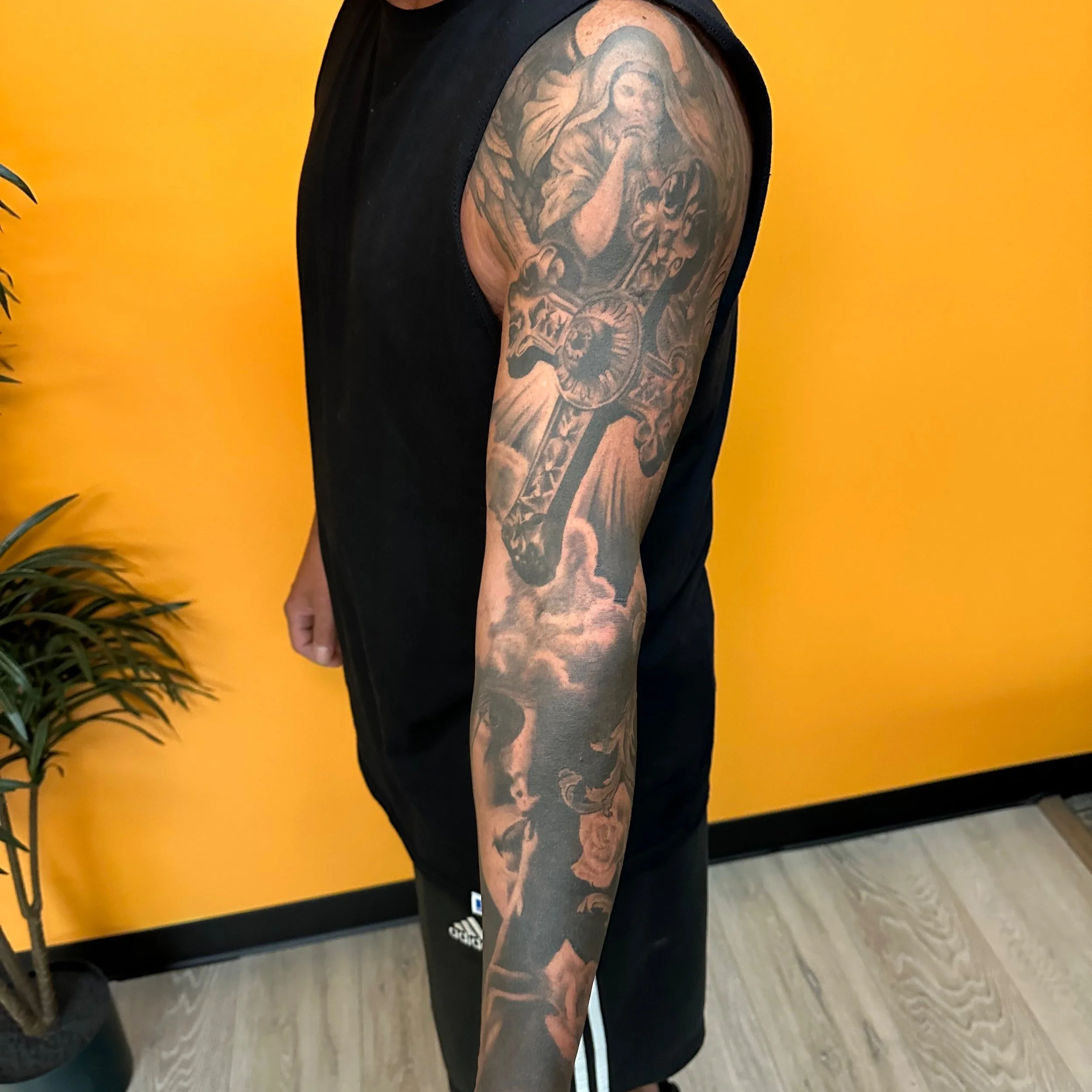 realistic black and grey sleeve tattoo by Judi Ramirez in Wilmington Delaware at Ink Oasis