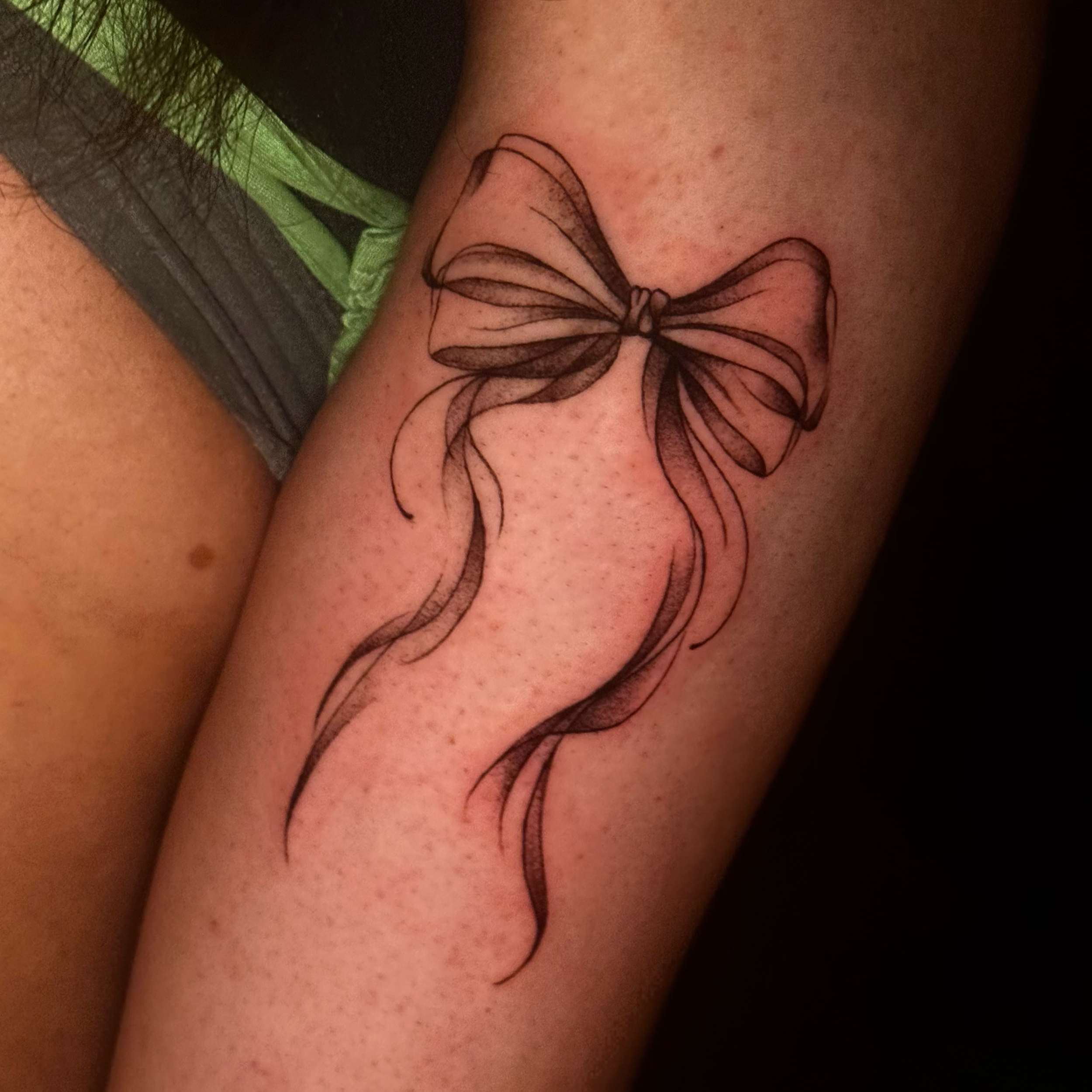 Close-up of a tattoo of a butterfly on a person's skin.
