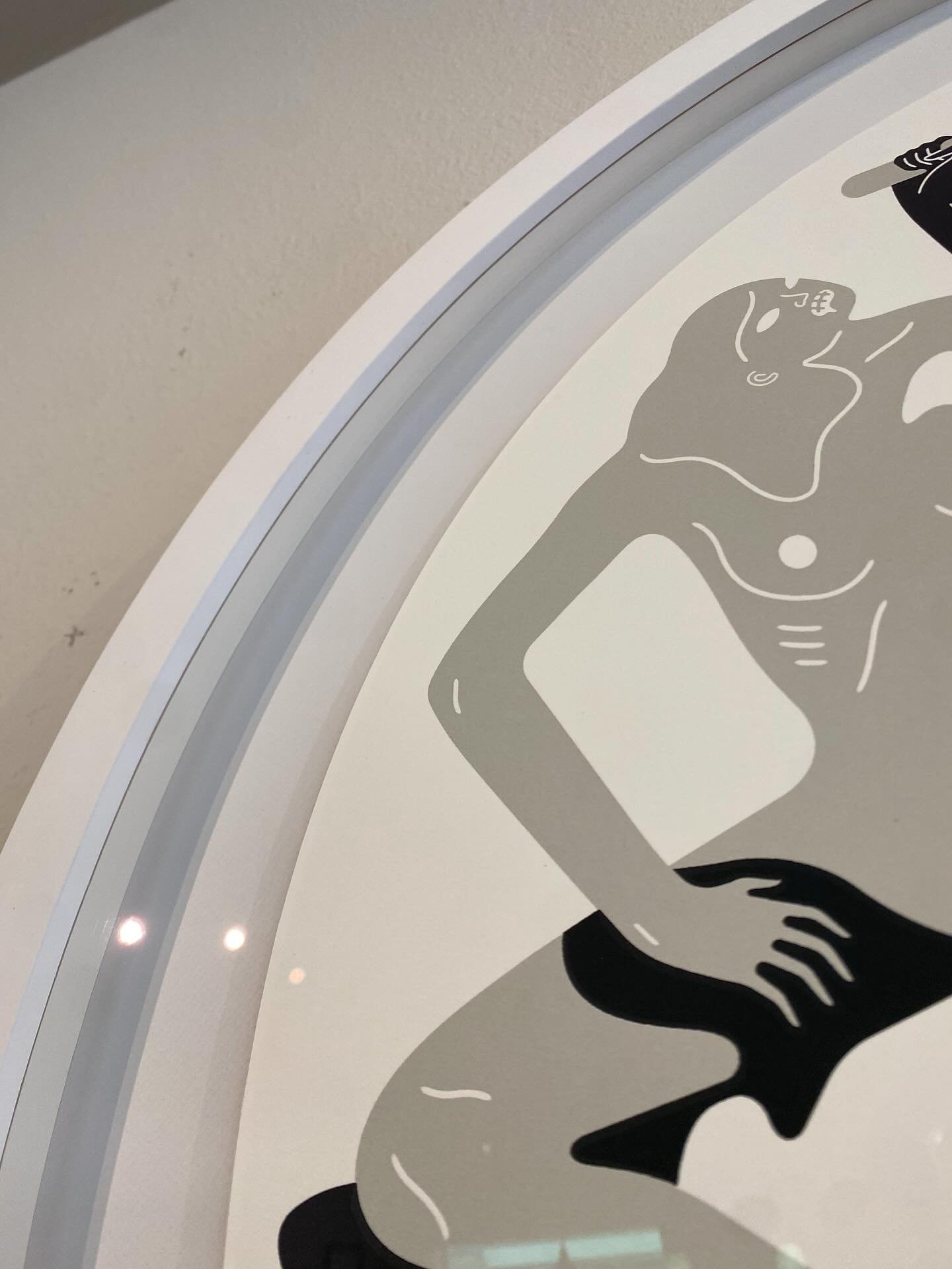 Custom white circular frame | Artwork floated with a raise with spacers. These spacers not only help with the floated look but they keep the artwork safely away from the glass, preventing any damage over time. You can imagine it would be a difficult 