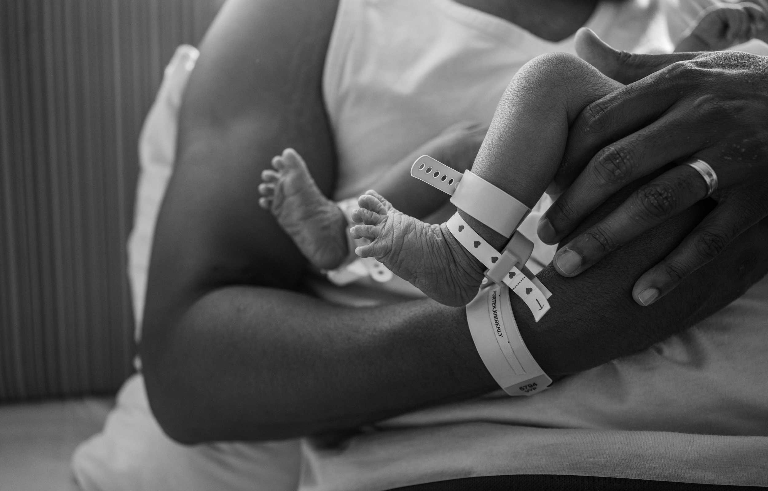 dad's arm with baby's feet