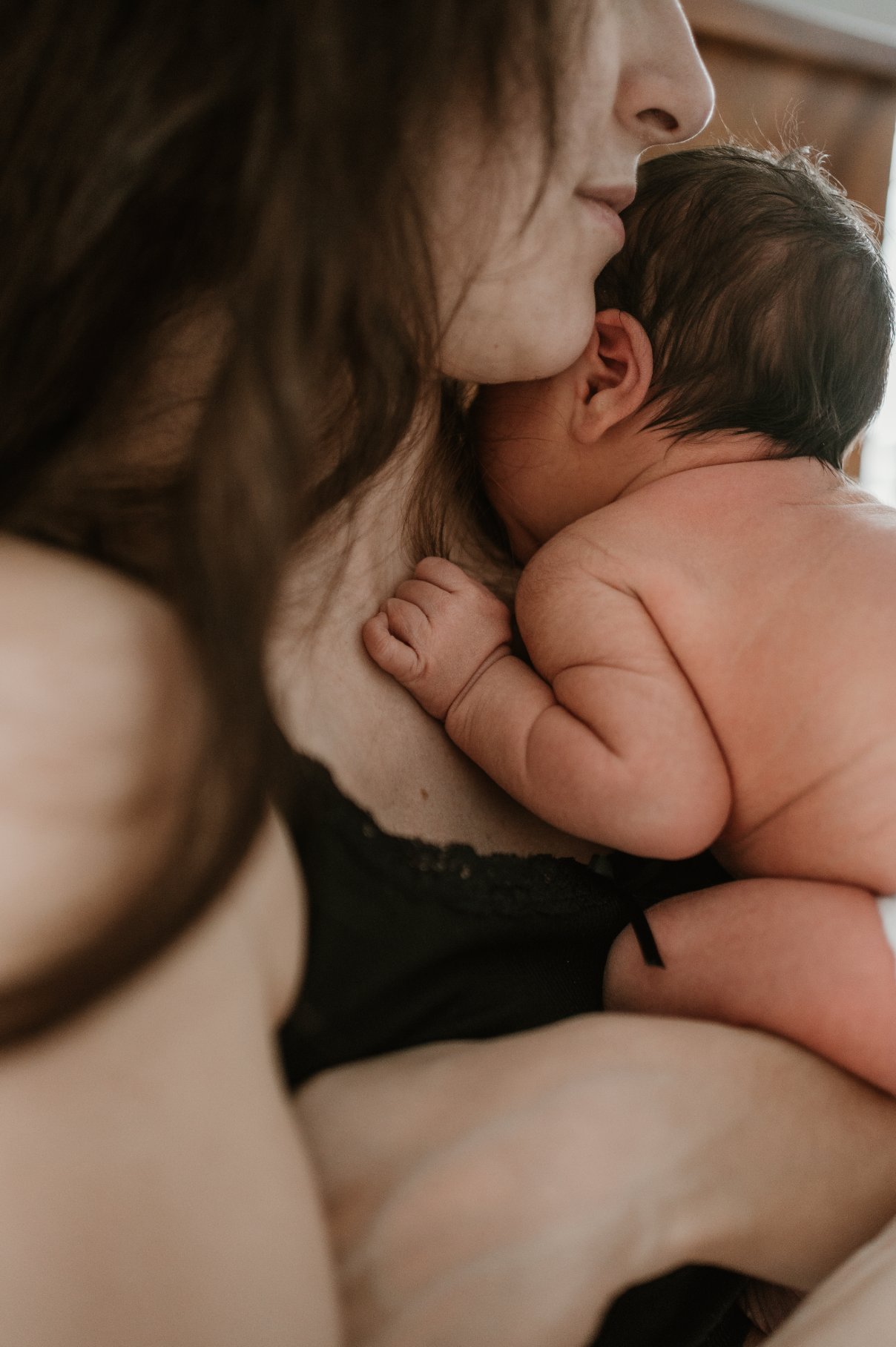 baby's hand on mom's chest