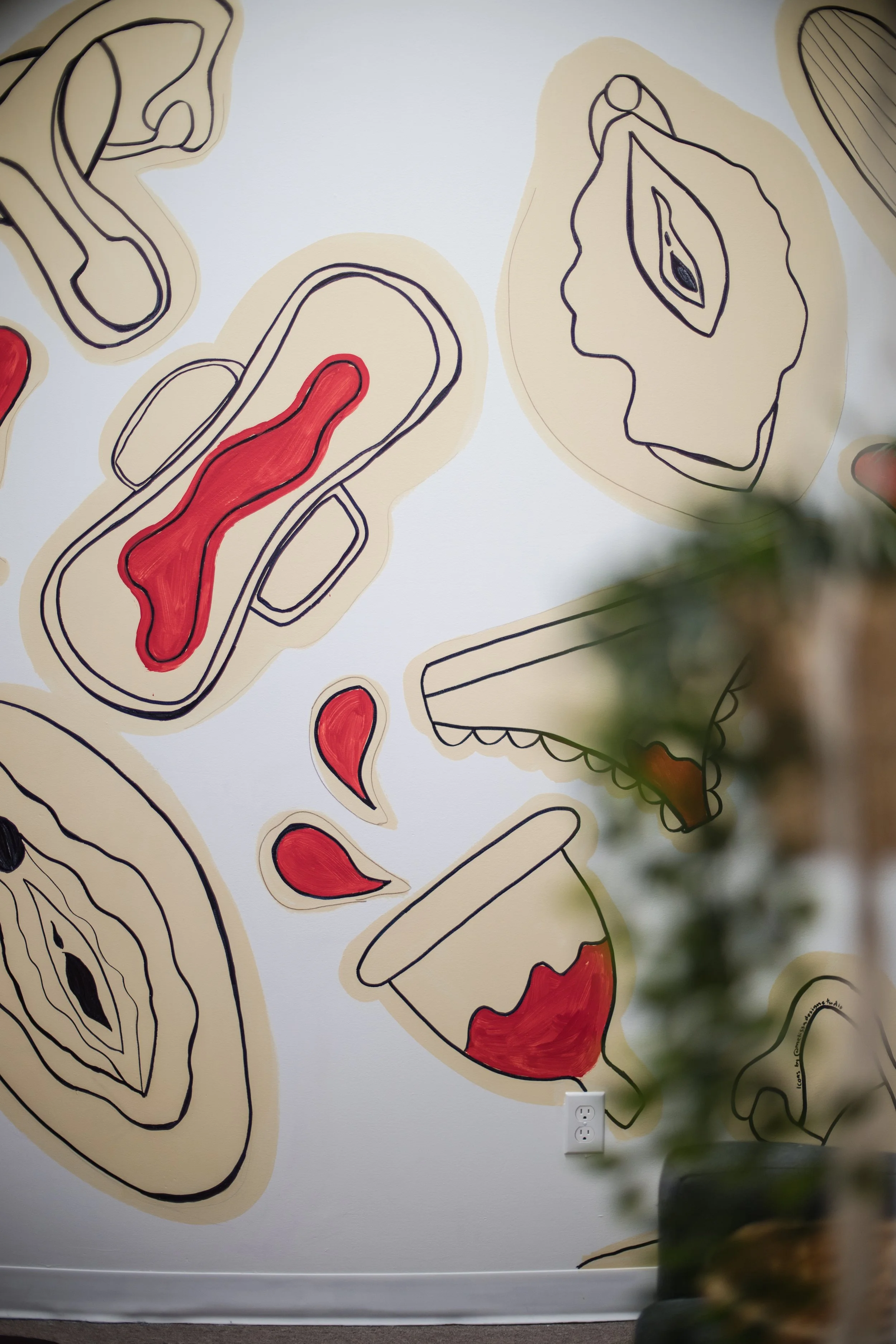 the cozy space at Moon and Bloom with the iconic menstrual themed wall! this space looks so much more amazing in real life!