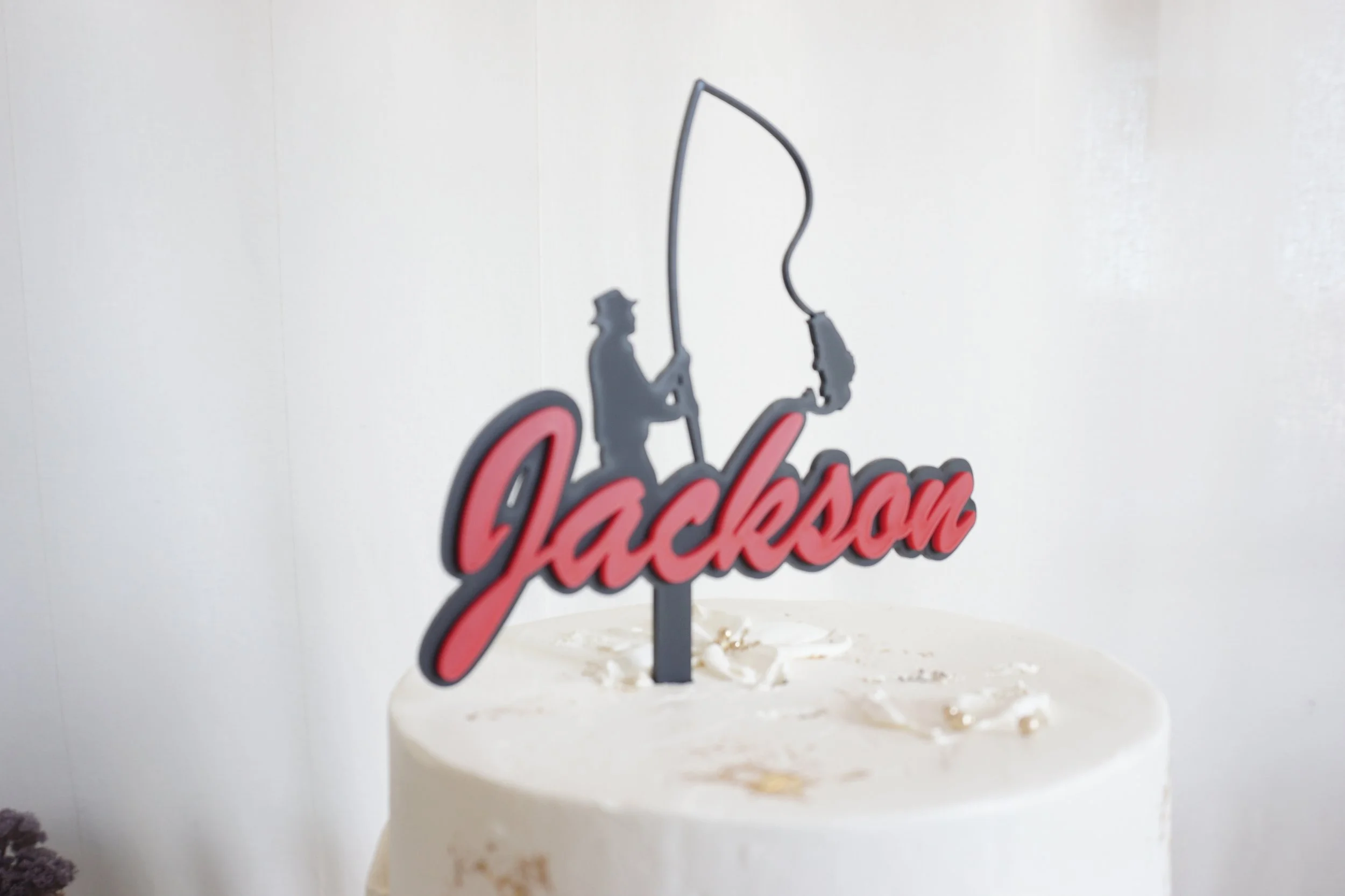 Jackson's cake topper featuring a fisherman catching a fish. The name of this topper can be changed. Made and designed in Sydney.