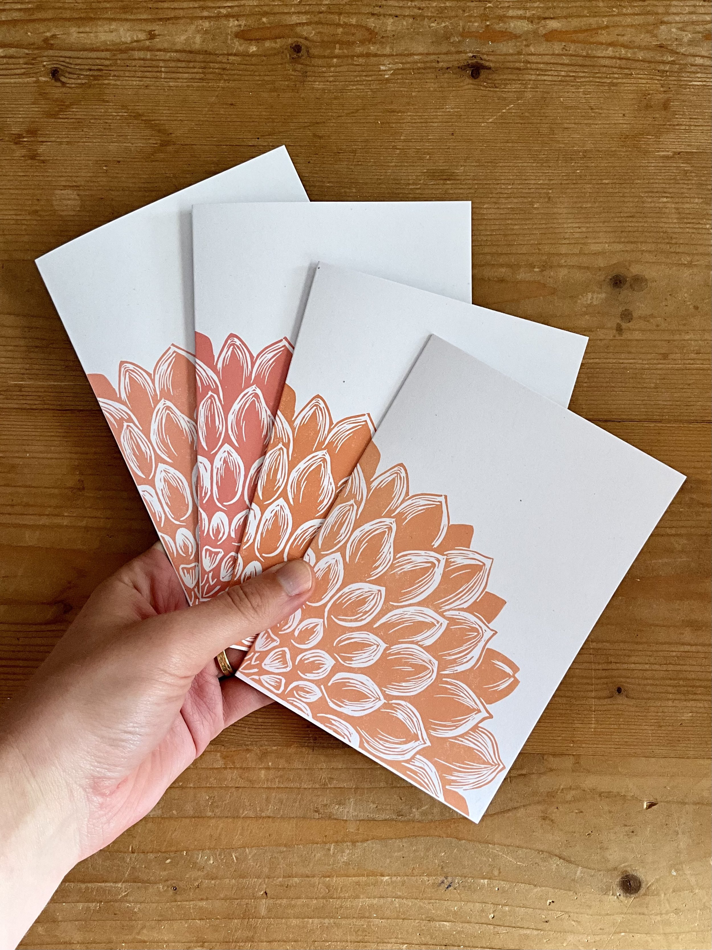 Mix of dahlia greeting card (A6), held in hand, printed in peach and pink tone