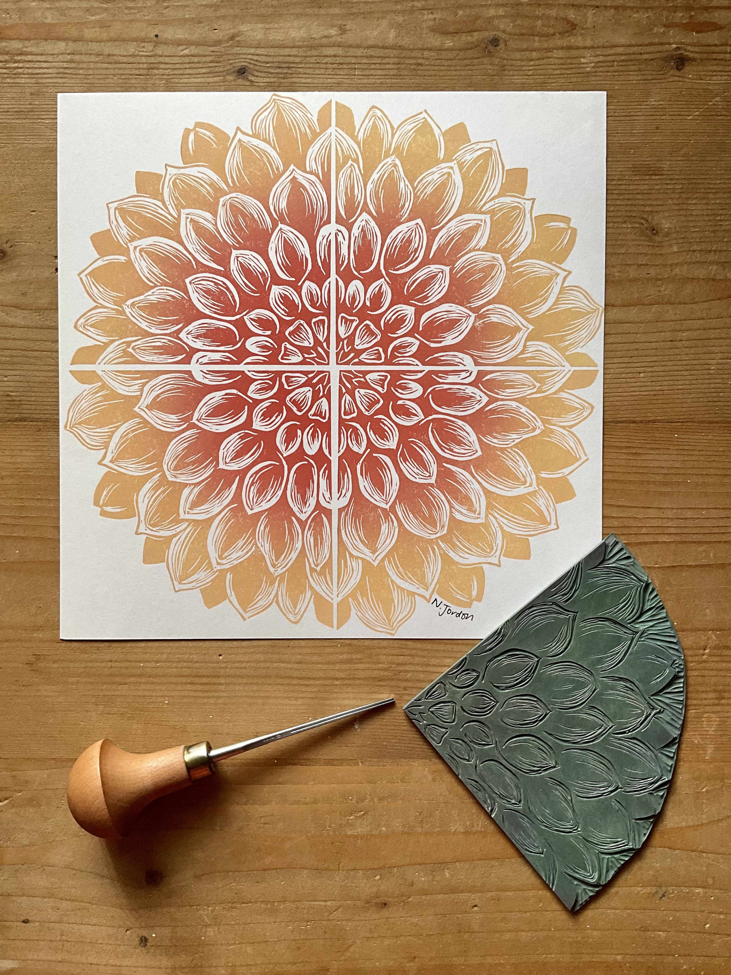 Full dahlia original lino cut print, in 21x21cm square. Hand printed in sand/tan ombrés. Photo also shows lino carving tool and the dahlia block used to print this piece.