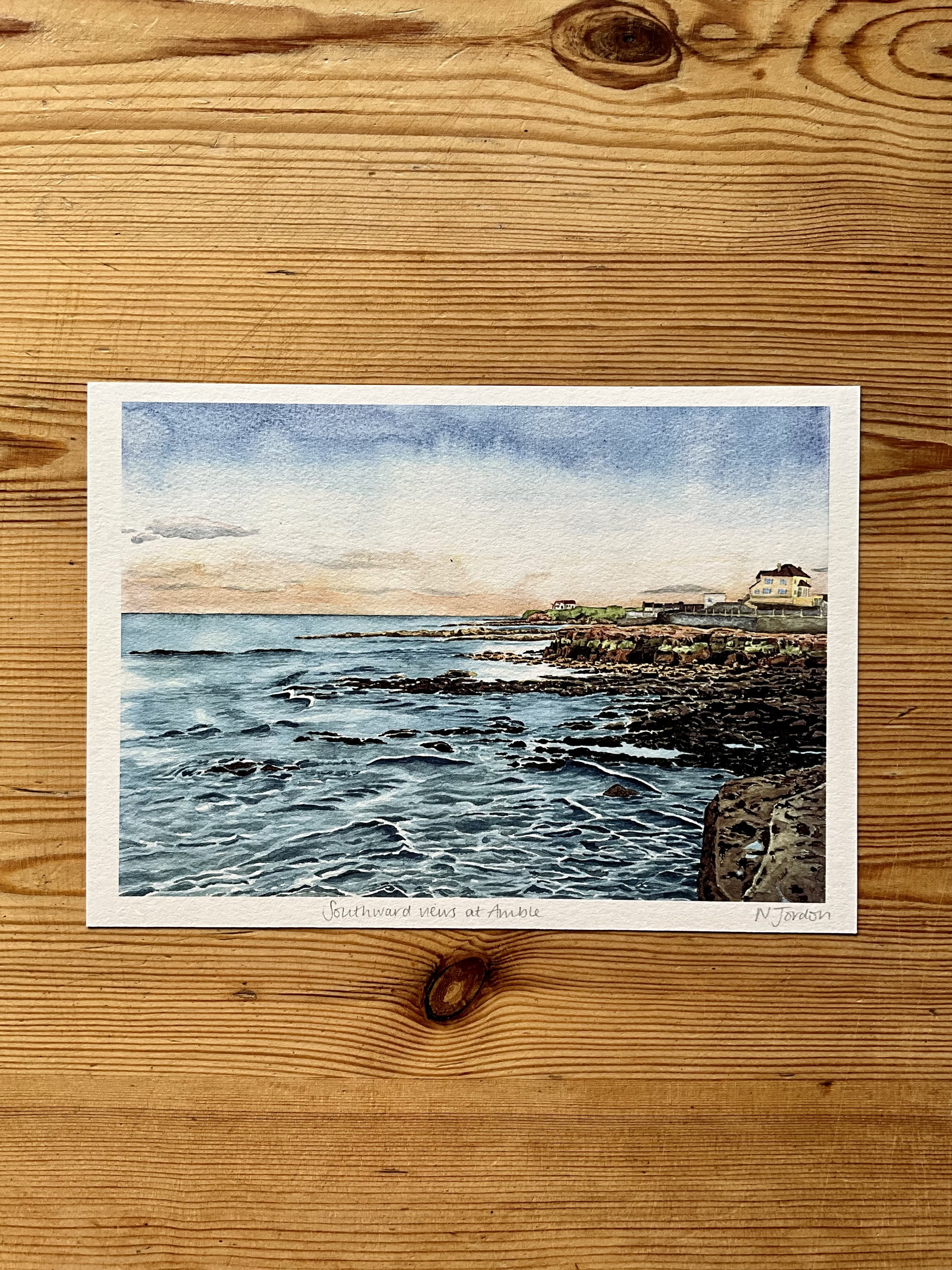 Art print of original A4 ‘Southward views from Amble’ watercolour painting. Printed onto textured paper, these art prints are available in a range of sizes. A5 is shown in this photo