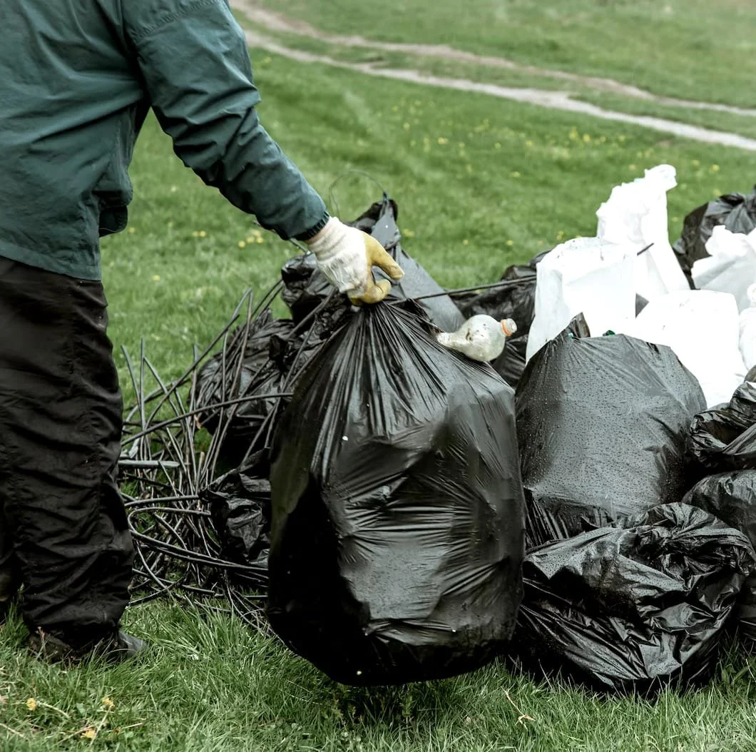 Person carrying rubbish bag