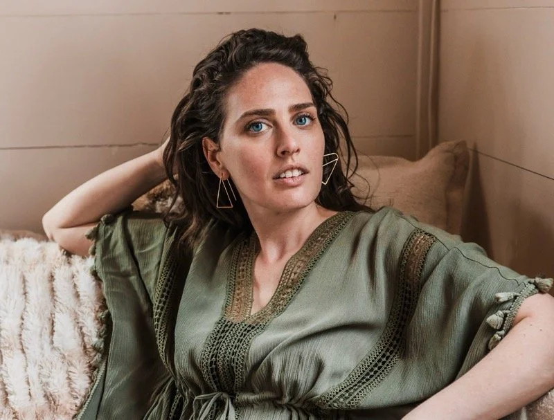 Sydney Zwicker portrait in green shirt, looking at camera