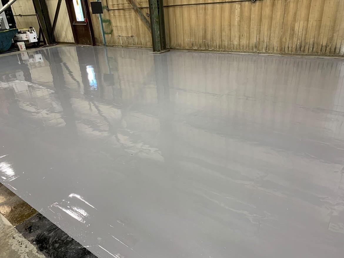 Smooth grey epoxy flooring in industrial setting