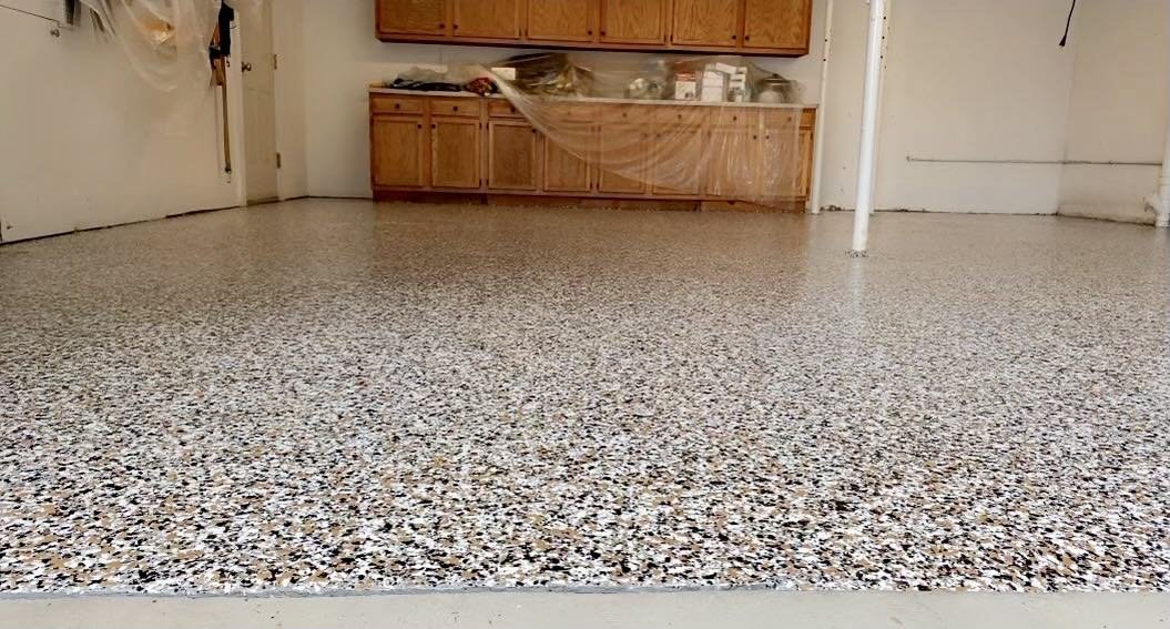 Epoxy garage floor with flake finish and wooden cabinets
