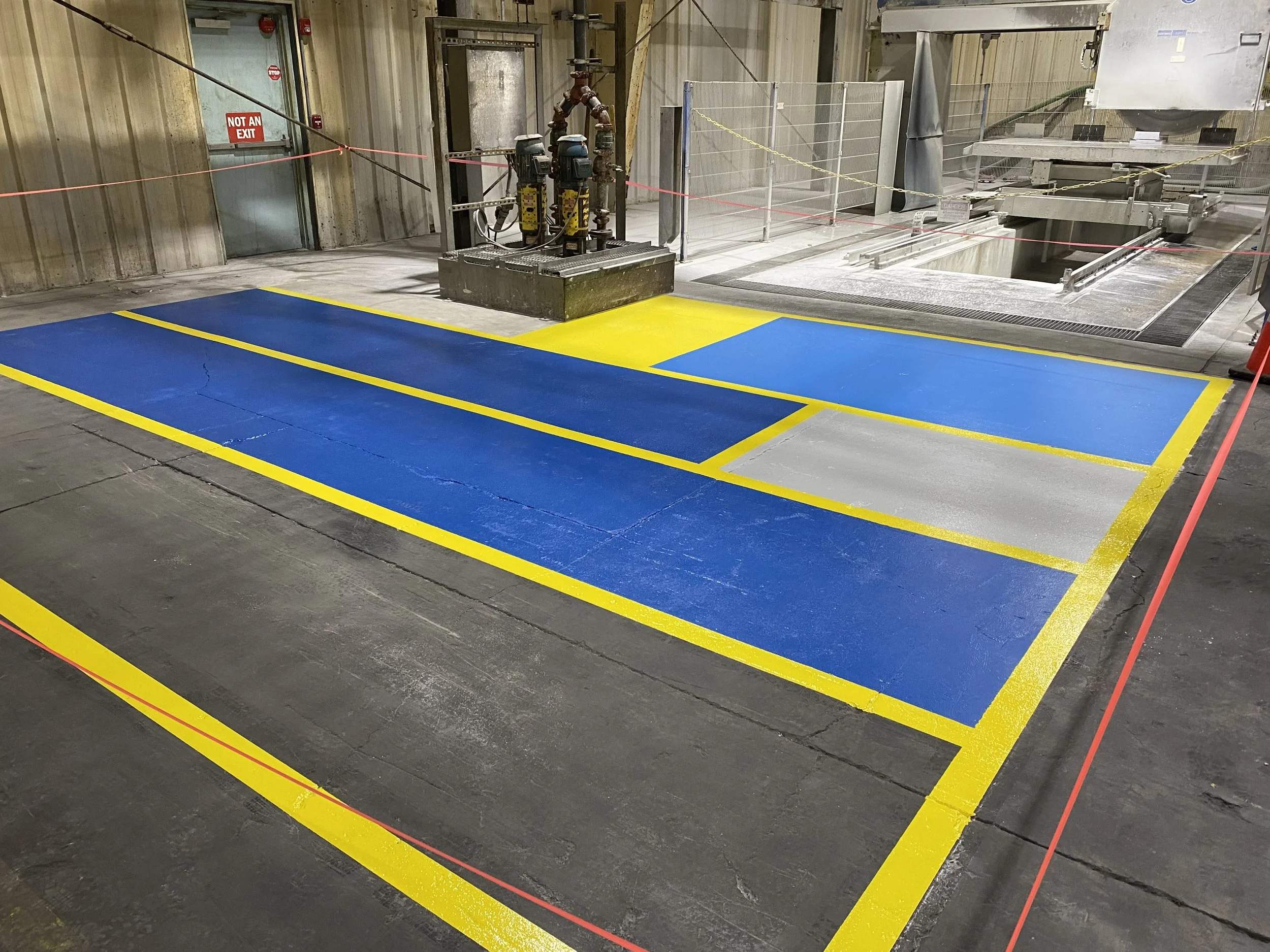 Industrial workspace with blue and yellow floor markings