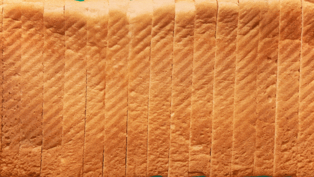 Close-up of a sliced loaf of bread showing a textured, crusty surface.