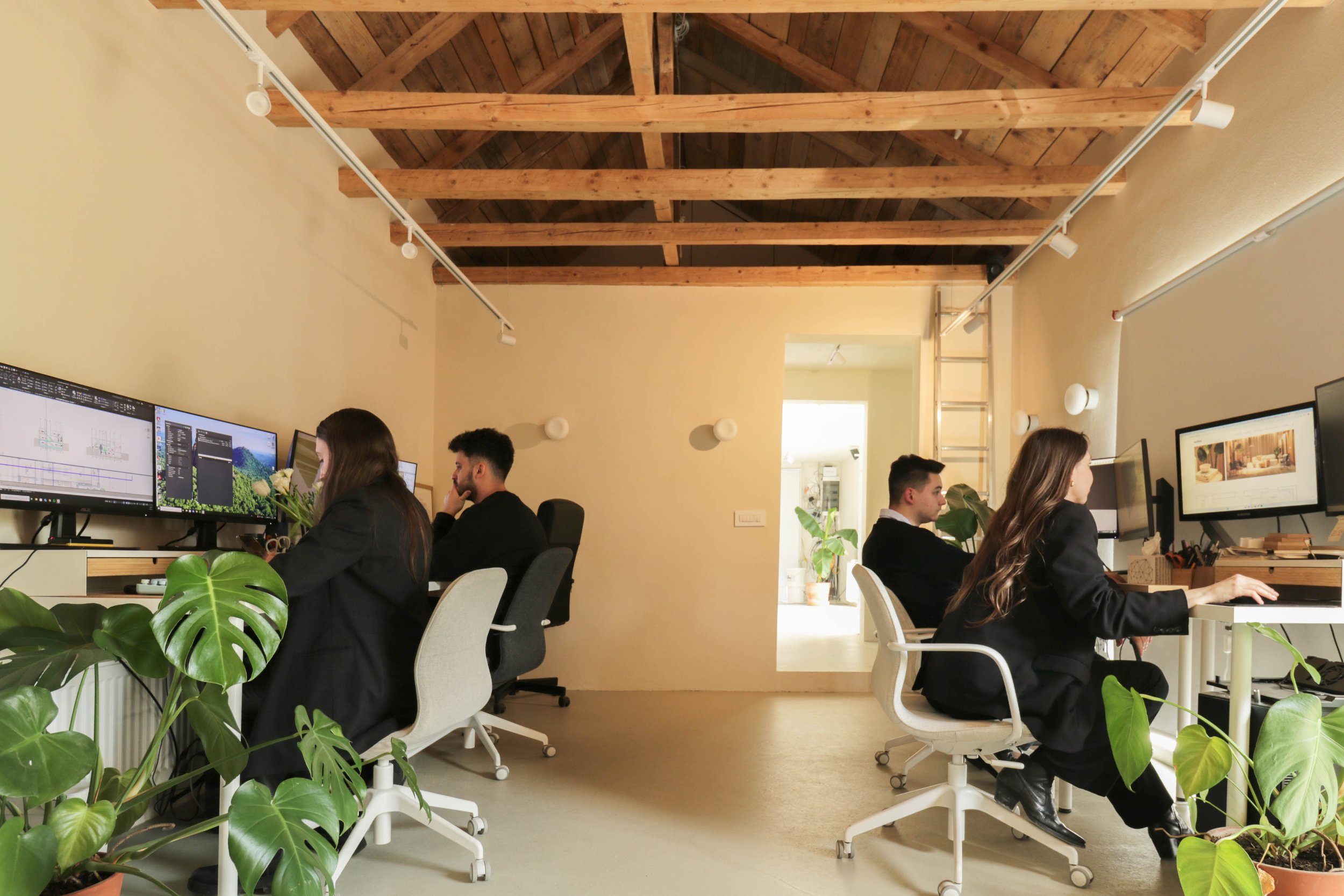 NNFTM architecture and interior design team collaborating in a modern studio workspace